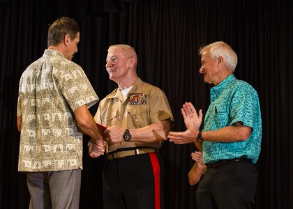 Mark Rigg (left), director, Honolulu Emergency Services Department, receives an award from Lt. Gen. John A. Toolan (middle), commander, U.S. Marine Corps Forces, Pacific, and Mayor Kirk Caldwell (right), City & County of Honolulu, during the First Responder Recognition Ceremony at the Neal S. Blaisdell Center, in Honolulu, Dec. 18, 2015. Various individuals from the Honolulu Emergency Services Department, Honolulu Fire Department, and Honolulu Police Department were recognized for their heroic, selfless actions while responding to a mishap involving an MV-22 tilt-rotor aircraft. 