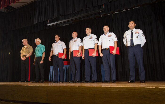 Lt. Gen. John A. Toolan, commander, U.S. Marine Corps Forces, Pacific and Mayor Kirk Caldwell, City & County of Honolulu, award U.S. Airmen during the First Responder Recognition Ceremony at the Neal S. Blaisdell Center, in Honolulu, Dec. 18, 2015.  Military and civilian personnel that selflessly assisted during the rescue and treatment of the Marines and Sailor received recognition from the U.S. Marine Corps Forces, Pacific Commander.