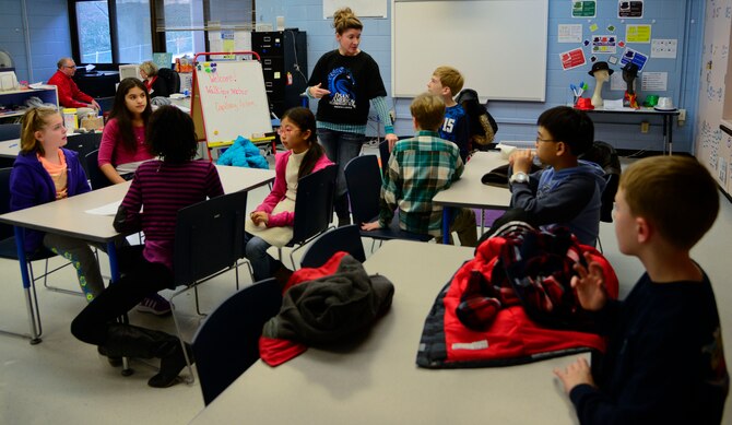 Valerie Rainey, Osan American Elementary School staff development teacher, speaks with student council members on Osan Air Base, Republic of Korea, Dec. 17, 2015. The students gathered to help load donated items for MyungJin Orphanage in Seoul. (U.S. Air Force photo/Senior Airman Kristin High)