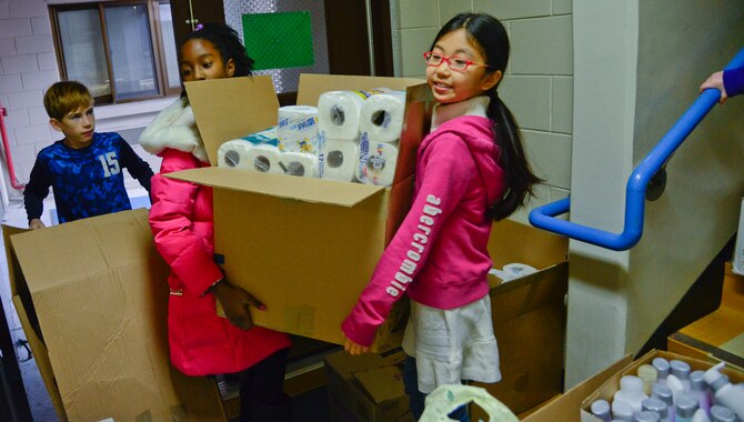 Student council members from the Osan American Elementary School carry donated items on Osan Air Base, Republic of Korea, Dec. 17, 2015. The students collected essential items during their “5 Days of Christmas” drive for MyungJin Orphanage in Seoul. (U.S. Air Force photo/Senior Airman Kristin High)