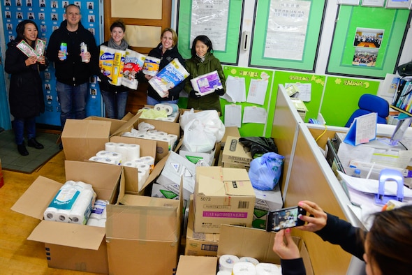 Osan American Elementary School student council advisors and MyungJin Orphanage caregivers pose with donations at the MyungJin Orphanage in Seoul, Republic of Korea, Dec. 17, 2015. The student council provided donations to give during the holiday season with their “5 Days of Christmas” drive. (U.S. Air Force photo/Senior Airman Kristin High)