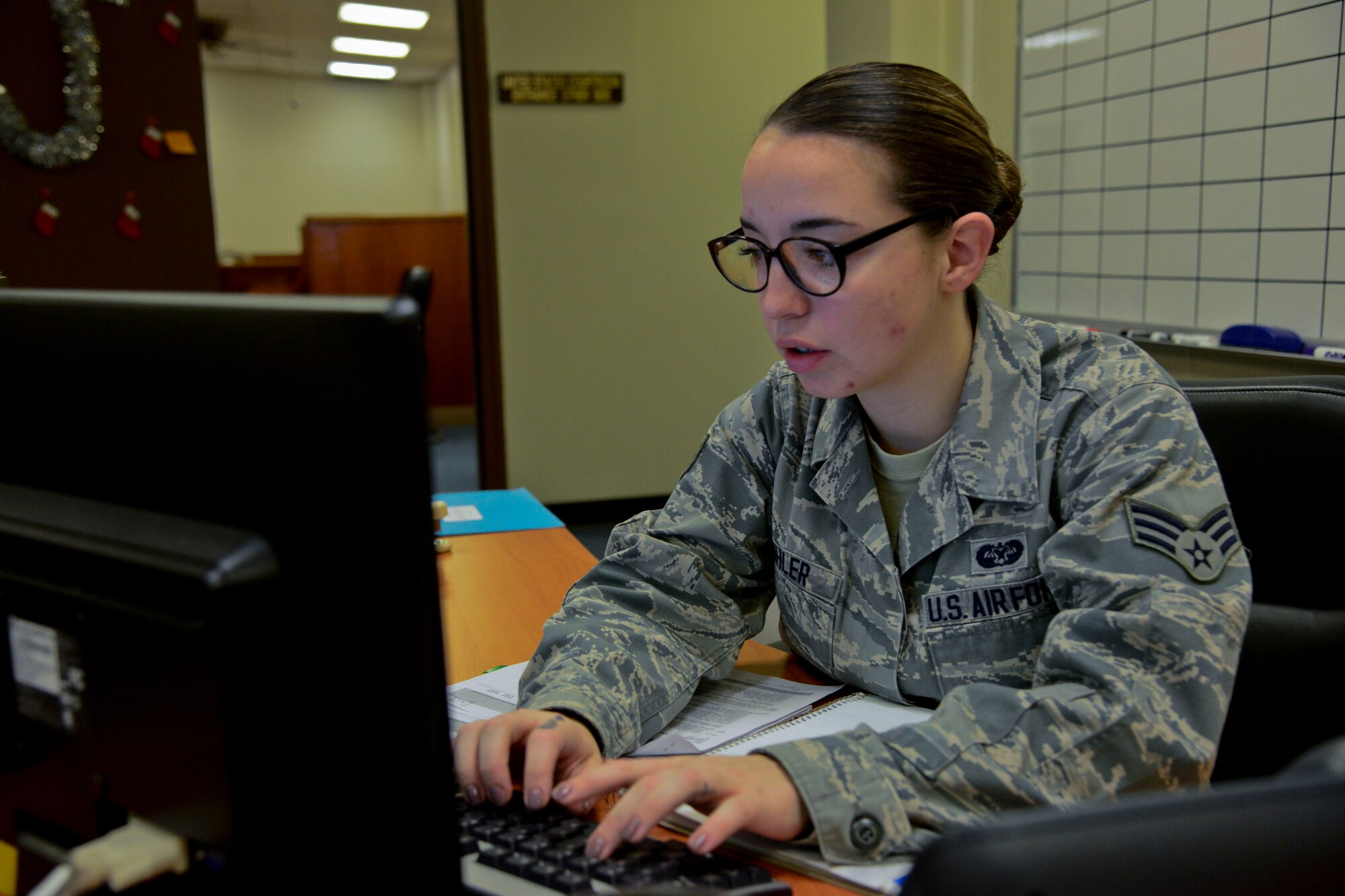 Senior Airman Belinda Kohler, 51st Fighter Wing judge advocate paralegal, logs documents in the legal office on Osan Air Base, Republic of Korea, Dec. 15, 2015. Although the legal office provides a multitude of services, they cannot assist clients with any criminal matter, personal commercial enterprises or business, issues on behalf of third parties, representation in court or administrative hearing or the preparation of real estate documents or living trusts. The legal office does assist with notary, wills, powers of attorney, immigration, domestic relations and Servicemembers Civil Relief Act matters. (U.S. Air Force photo/Senior Airman Kristin High)