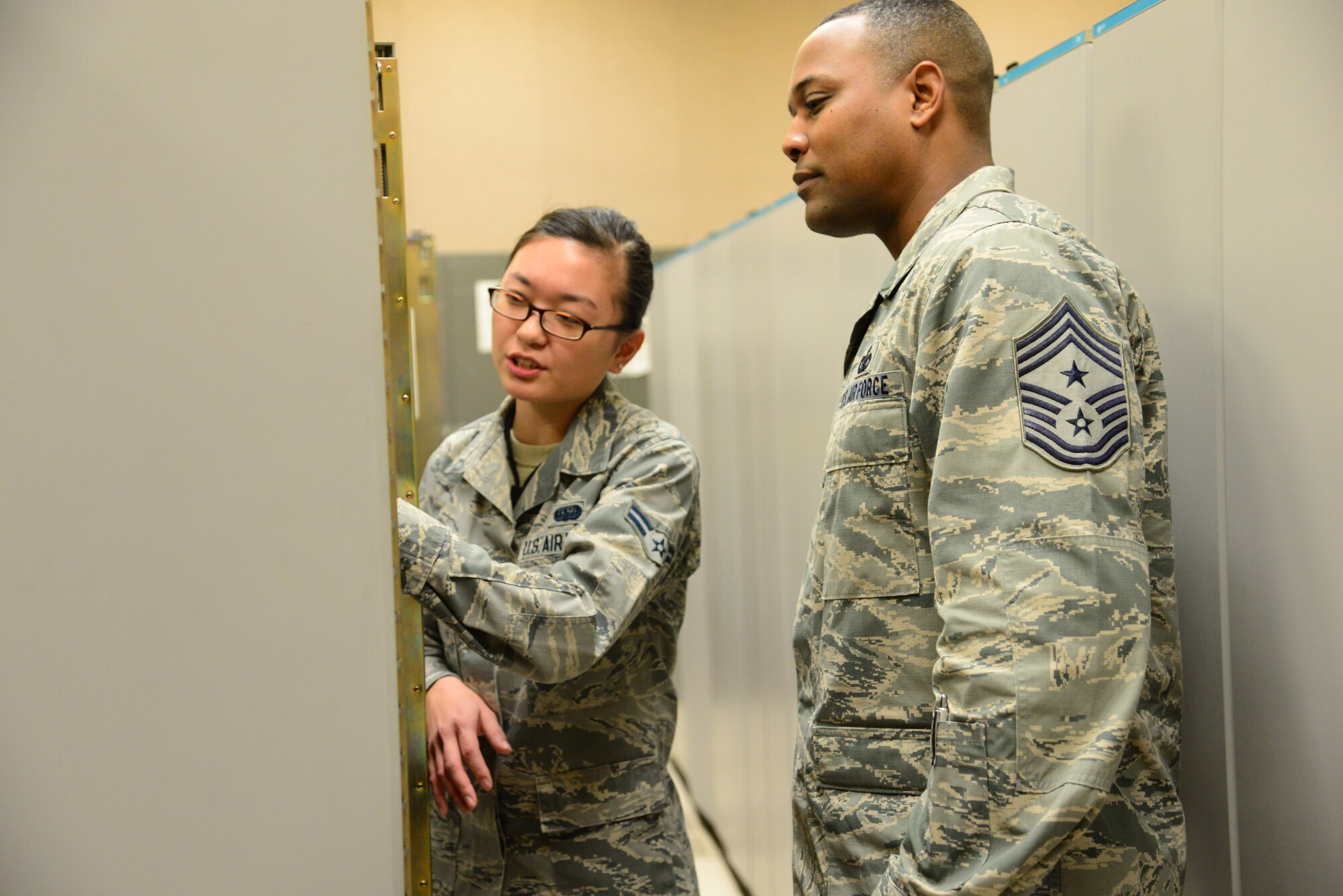 Airman 1st Class Emi Kozaki, 51st Communications Squadron network management technician, briefs 7th Air Force Command Chief Master Sgt. Anthony Johnson, on the intricacies of the squadron’s mission during immersion tour at Osan Air Base, Republic of Korea, Dec. 10, 2015. Johnson spent his day touring various aspects of 51st Mission Support Group and met with many of the squadron’s Airmen. (U.S. Air Force photo/Staff Sgt. Amber Grimm)