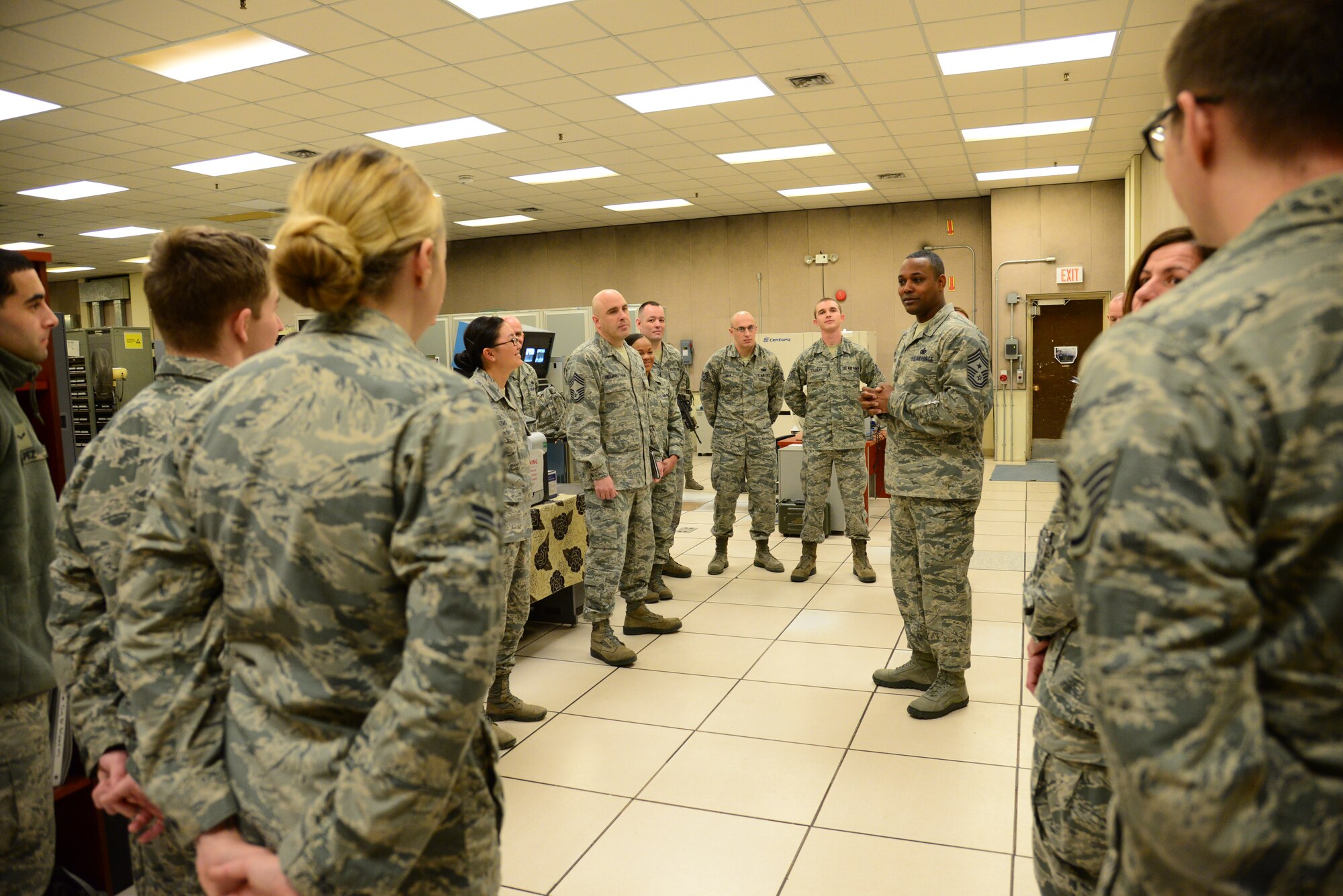 Seventh Air Force Command Chief Master Sgt. Anthony Johnson, takes a moment to speak with the Airmen of the 51st Communications Squadron during his immersion day with the 51st Mission Support Group at Osan Air Base, Republic of Korea, Dec. 10, 2015. Johnson spent his day touring various aspects of 51st MSG. (U.S. Air Force photo/Staff Sgt. Amber Grimm)