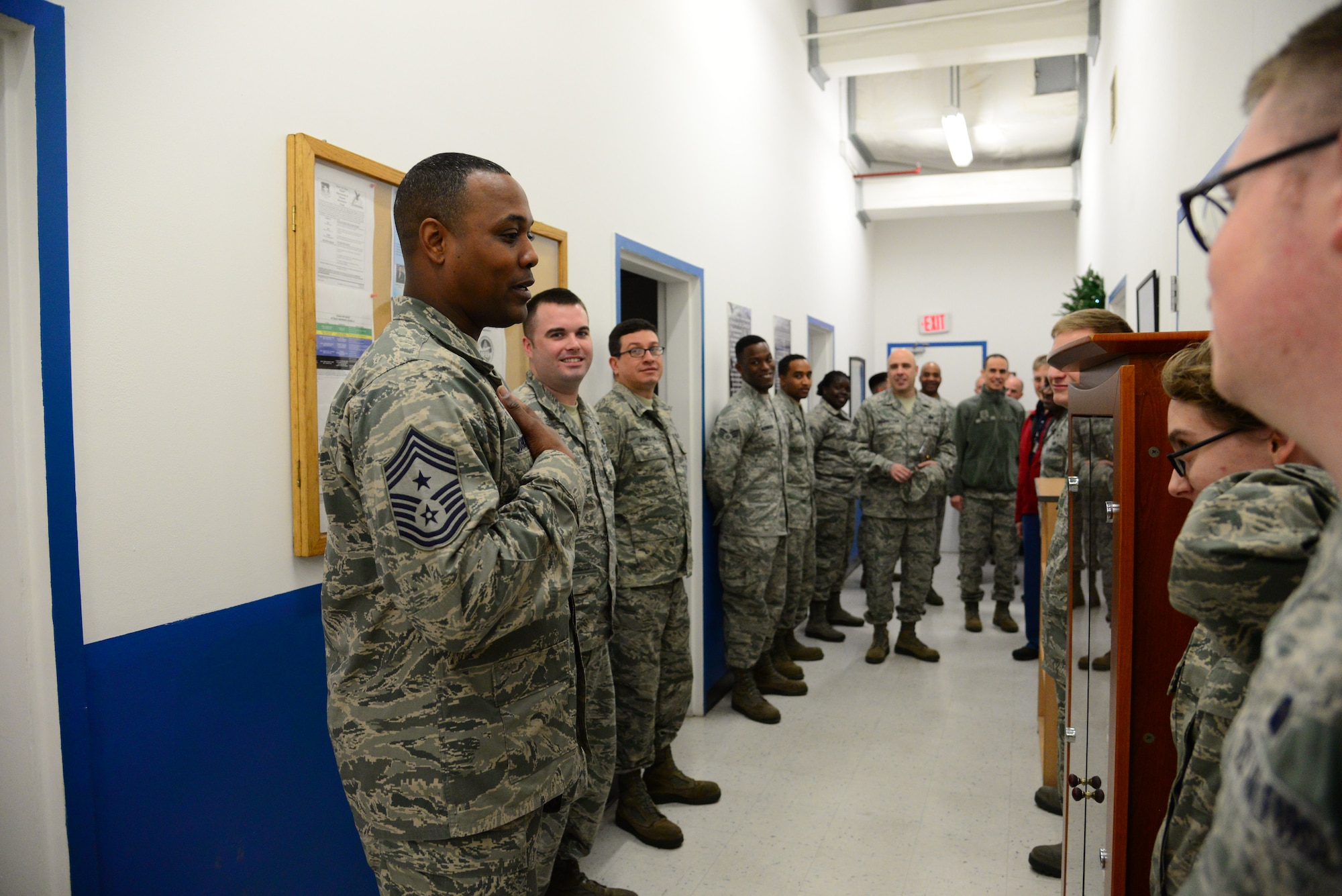 Seventh Air Force Command Chief Master Sgt. Anthony Johnson, speaks with 51st Communications Squadron postal service Airmen at Osan Air Base, Republic of Korea, Dec 10, 2015.  Johnson spent the day becoming more familiar with the missions, organizations and Airmen that make up 51st MSG. (U.S. Air Force photo/Staff Sgt. Amber Grimm)