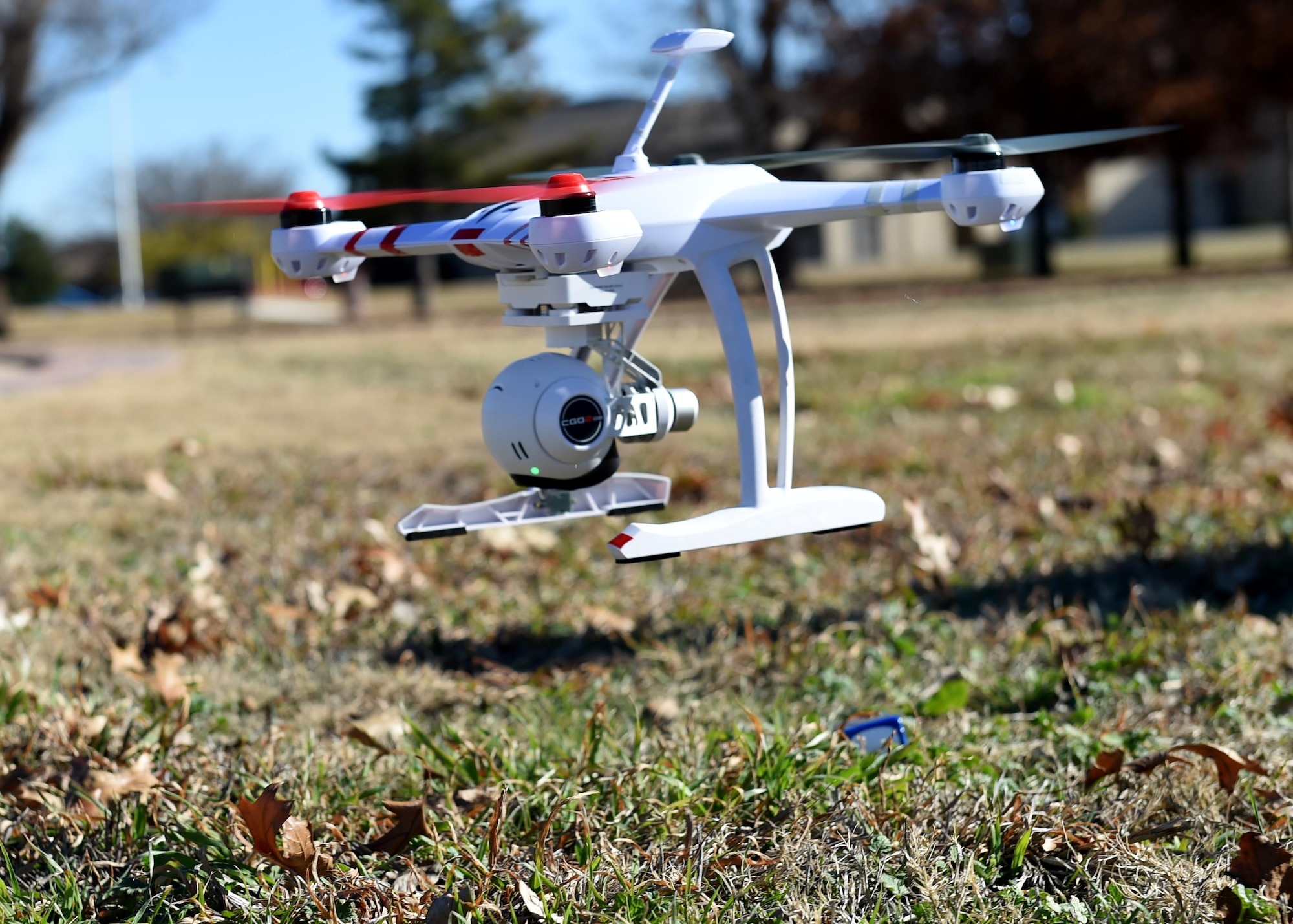 A drone is flown to demonstrate how it is used for official purposes at Wings of Freedom Park, Dec. 15, 2015. With the increase of drones’ popularity in the last few years, laws restricting the use of drones within 5 miles of an airbase have been made but some exceptions are made for official tasks such as checking roofs and showing cleared roadways on base. (U.S. Air Force photo by Airman 1st Class Kirby Turbak/Released)