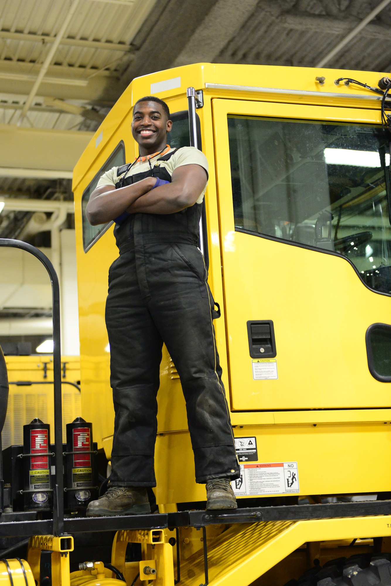 U.S. Air Force Senior Airman Dion Edwards, a 354th Logistics Readiness Squadron vehicular equipment maintenance mechanic, takes a quick break Dec. 16, 2015, at Eielson Air Force Base, Alaska. Edwards said his favorite part of his job is learning to fix all different types of vehicles. (U.S. Air Force photo by Airman 1st Class Cassandra Whitman/Released)