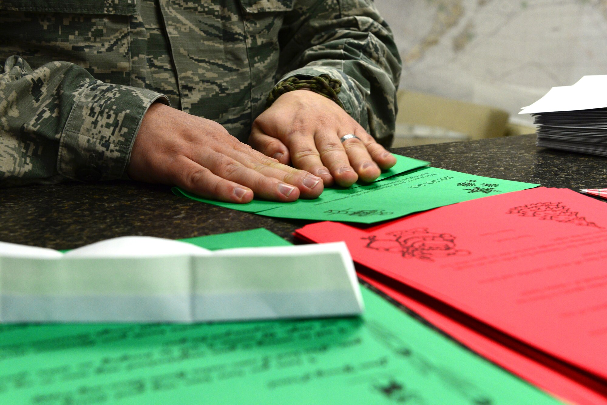 U.S. Air Force Staff Sgt. Cody Howk, a 354th Operations Support Squadron weather forecaster, folds a letter Dec. 16, 2015, at Eielson Air Force Base, Alaska. There are different letters to send to children who write to Santa. They do this in case of siblings, so each receives a different letter as part of “Santa’s Mailbag.” (U.S. Air Force photo by Airman 1st Class Cassandra Whitman/Released)