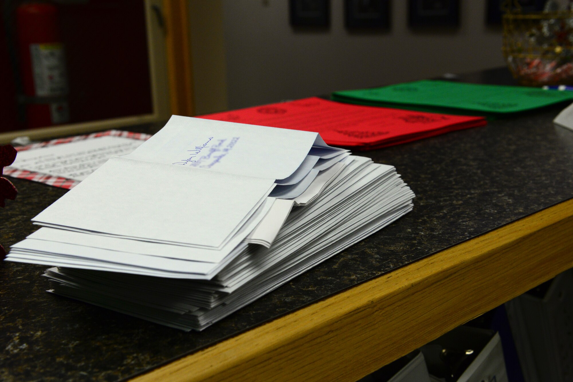 A stack of pre-addressed envelopes sits on the counter waiting to be filled with a letter from Santa, Dec. 16, 2015, at Eielson Air Force Base, Alaska. Children from all over the world send their Christmas letters to Santa and they end up at the 354th Operations Support Squadron weather flight. Members from the weather flight open the letters and send letters back to the children as part of “Santa’s Mailbag.” (U.S. Air Force photo by Airman 1st Class Cassandra Whitman/Released)