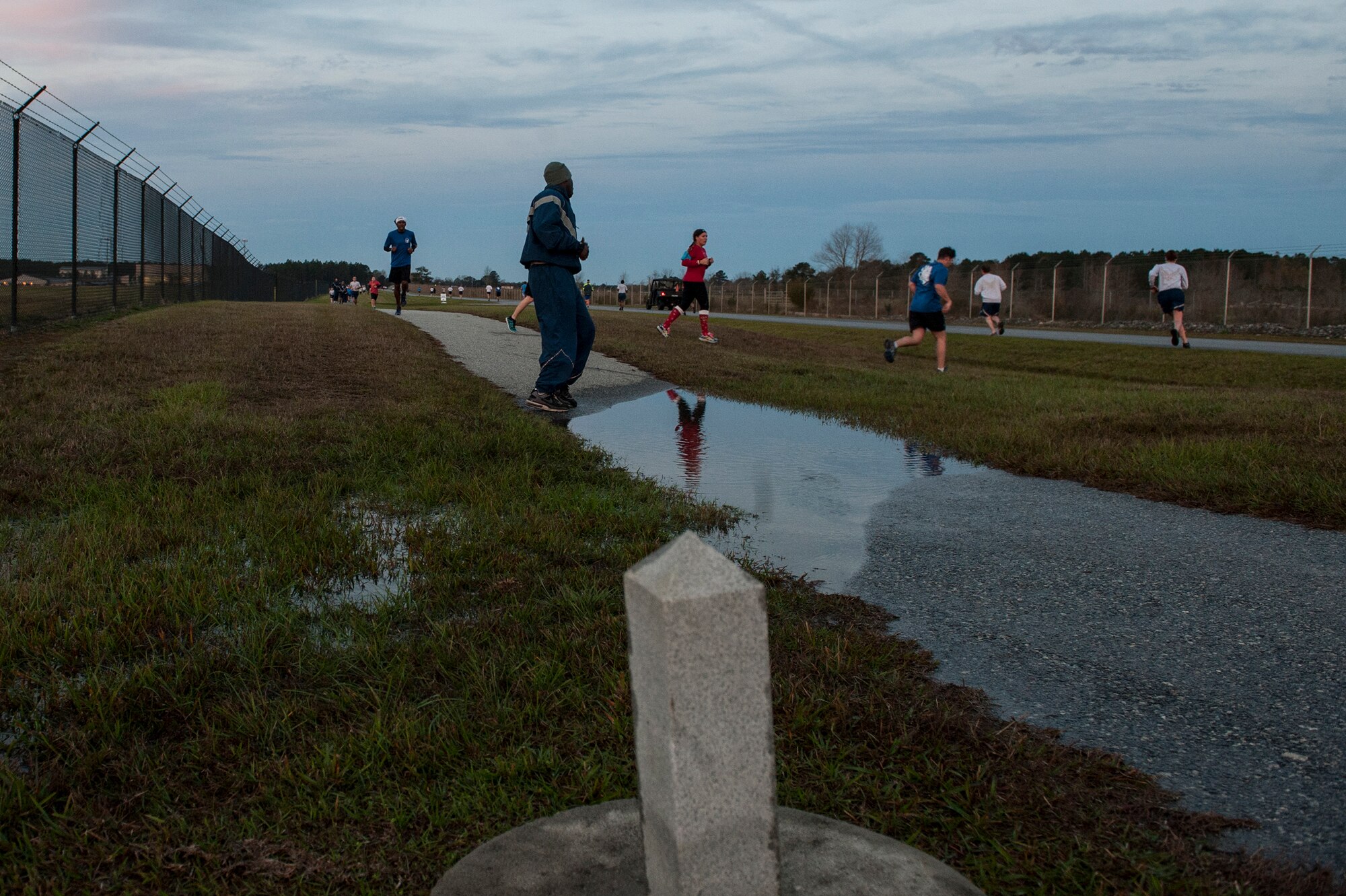 Runners turn around at the halfway marker during the Santa 5k, Dec. 18, 2015, at Moody Air Force Base, Ga. During the run, participants wore holiday sweatshirts, hats and socks to show their spirit. (U.S. Air Force photo by Airman 1st Class Lauren Johnson/Released)