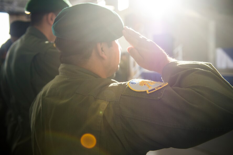 An Afghan air force pilot salutes during the playing of the Afghan national anthem at the graduation of the first 81st Fighter Squadron’s student pilot class, Dec. 18, 2015, at Moody Air Force Base, Ga. The 81st FS graduated eight Afghan air force students trained as combat ready attack pilots on the A-29 Super Tucano. (U.S. Air Force photo by Senior Airman Ceaira Tinsley/Released)