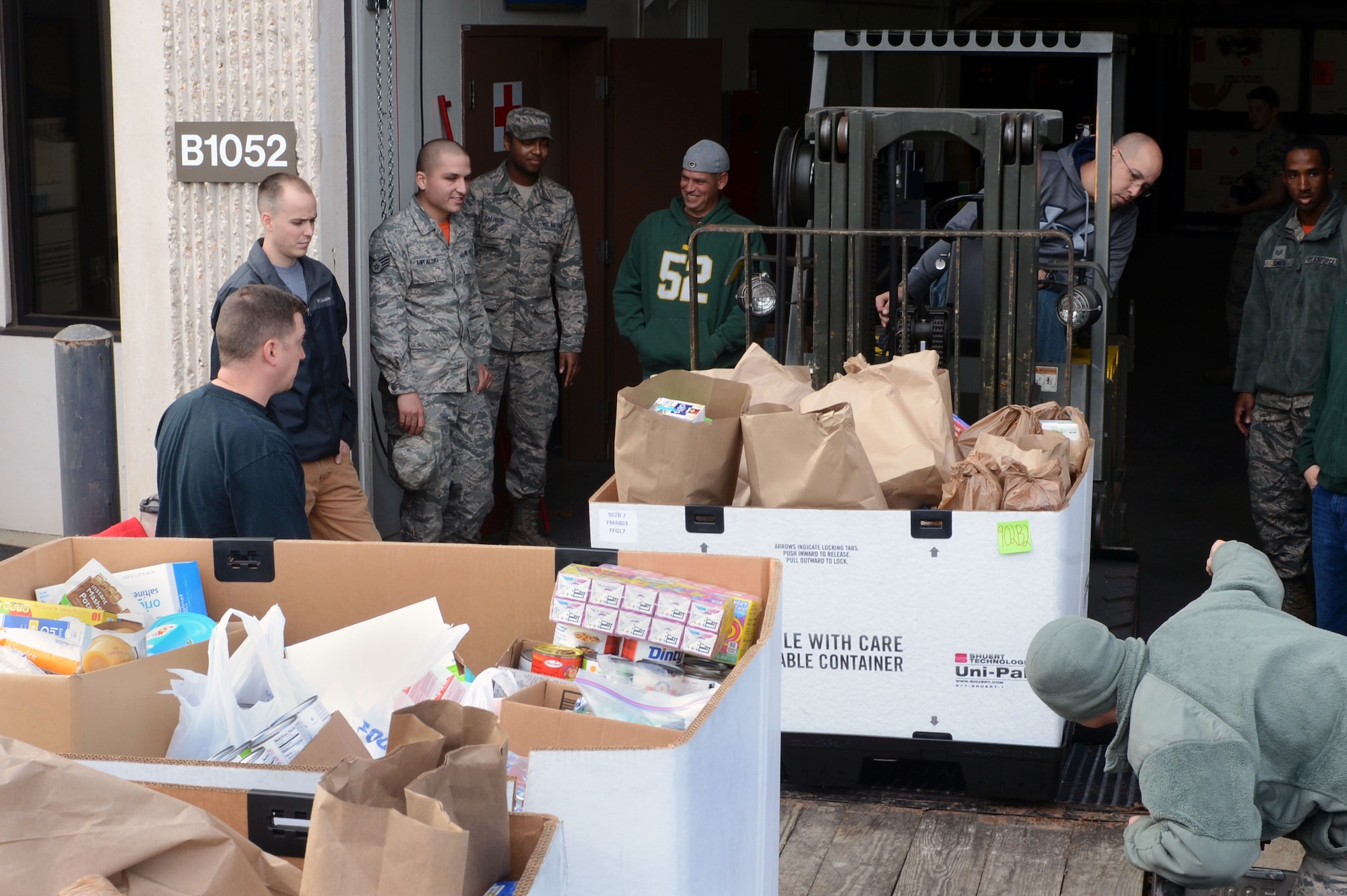 U.S. Air Force Master Sgt. Jason Hipple, 20th Logistics Readiness Squadron fuels management flight superintendent, loads food donations onto a trailer with Team Shaw personnel at Shaw Air Force Base, S.C., Dec. 18, 2015. In response to a robbery at a local Salvation Army’s food bank late last week, Team Shaw members collected approximately three tons of food and $2,300 over a five-day period. (U.S. Air Force photo by Senior Airman Zade Vadnais)