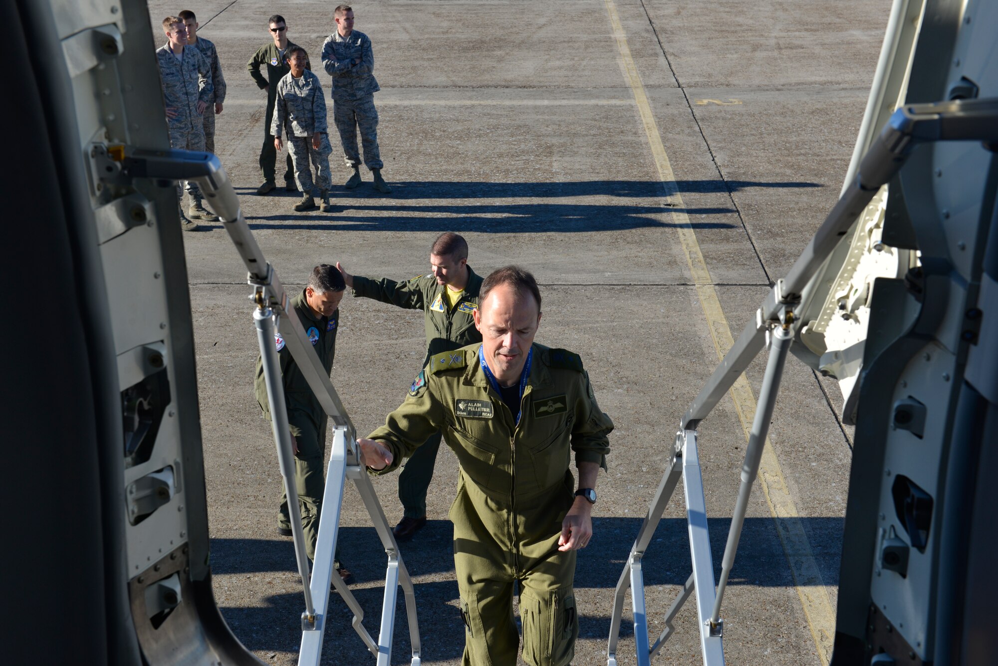 TYNDALL AIR FORCE BASE, Fla. -- Royal Canadian Air Force BGen Alain Pelletier, Continental U.S. Aerospace Defense Region Deputy Commander, climbs the stairs to board a Navy P-8A Poseidon aircraft from Naval Air Station Jacksonville here for static display Dec. 15. The aircraft is the Navy’s newest addition to its anti-submarine & intelligence, surveillance and reconnaissance platforms.  It’s the replacement for the P-3 Orion legacy aircraft, which in the past has proven valuable to the Air Forces Northern organization for the incident awareness and assessment portion of Defense Support of Civil Authorities missions. (Air Force Photo Released/Mary McHale)