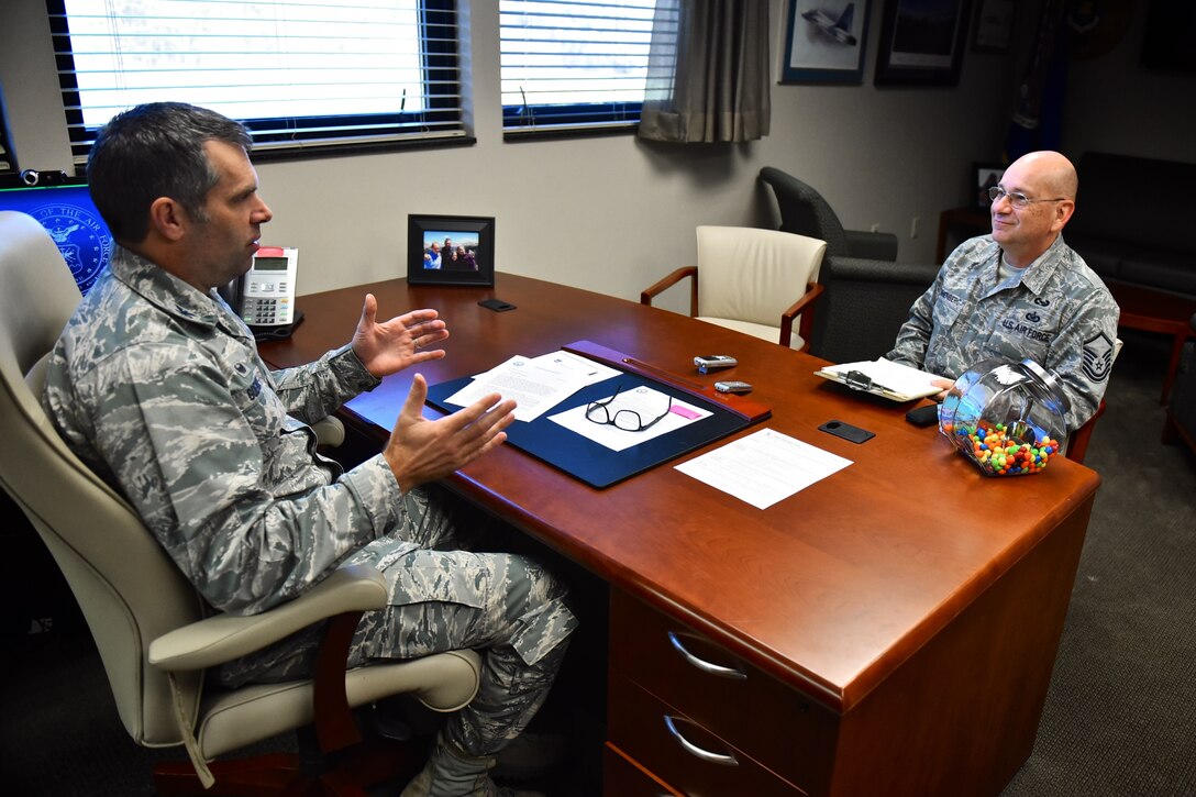 Col. Karl Goerke, 932nd Airlift Wing commander, speaks with Master Sgt. Gerald Sonnenberg, the 932nd AW historian, during an annual review of wing activities in 2015, as well as the commander's thoughts and overview of the year for use in the wing history, Dec. 18, 2015, Scott Air Force Base, Illinois.  (U.S. Air Force photo by Christopher Parr)