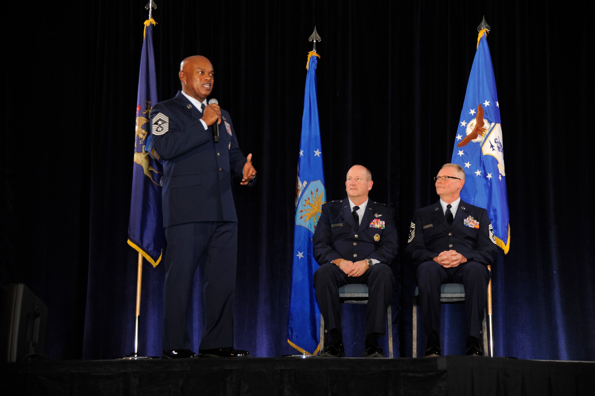 Chief Master Sgt. Tony Whitehead, command chief for the 127th Wing, addresses the Airmen of the Wing after assuming his duties as command chief during the Wing’s annual awards ceremony at Selfridge Air National Guard Base, Mich., Dec. 5, 2015. Listening to Whitehead are 127th Wing Commander Brig. Gen. John D. Slocum and 127th Wing Command Chief Master Sgt. Robert Dobson. (U.S. Air National Guard photo by Senior Airman Ryan Zeski)