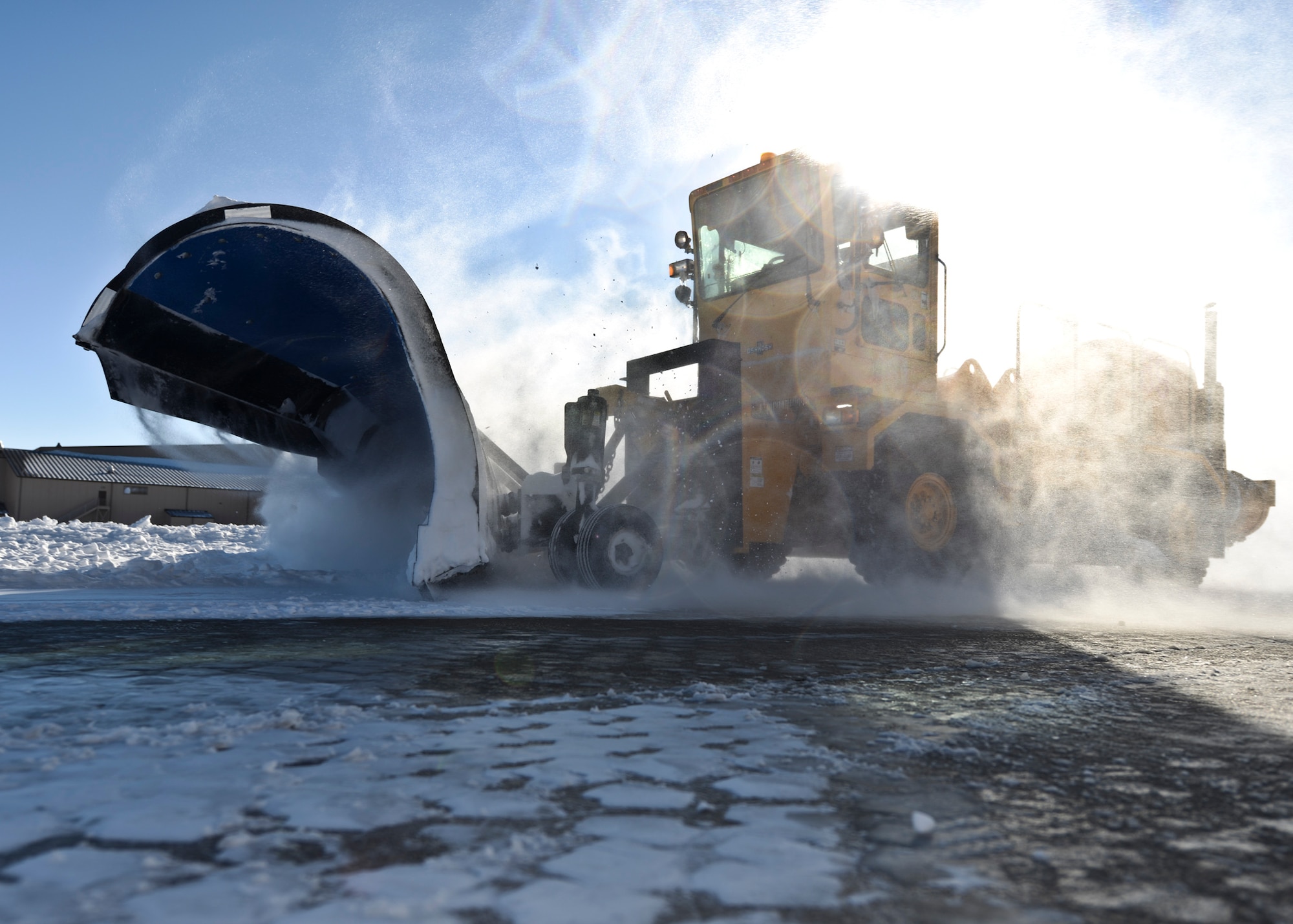 A member of the 28th Civil Engineering Squadron operates a plow to push snow off the flightline at Ellsworth Air Force Base, S.D., Dec. 16, 2015. The 28th Civil Engineer Squadron maintains 125 pieces of equipment and is in charge of clearing the airfield and the base streets during inclement weather. (U.S. Air Force photo by Airman Sadie Colbert/Released) 