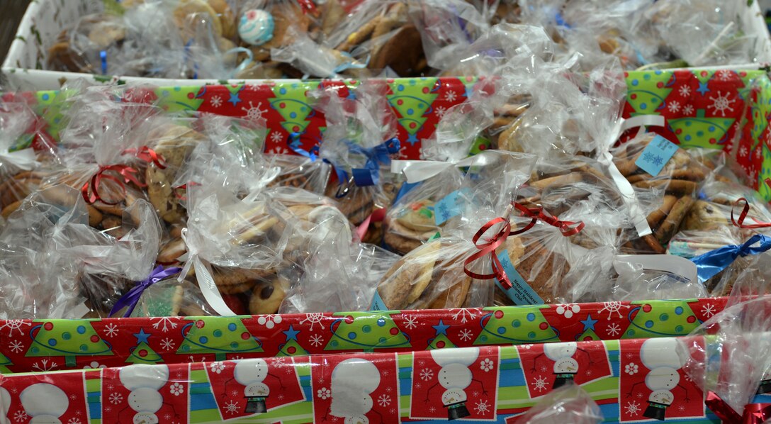 Volunteers fill bins with baked goods packaged during the Enlisted Spouse’s Club 4th annual Holiday Cookie Drive at Ellsworth Air Force Base, S.D., Dec. 13, 2015.  The cookies were made as a thank you gift for Ellsworth Airmen during the holiday season. (U.S. Air Force photo by Airman Donald C. Knechtel/Released)