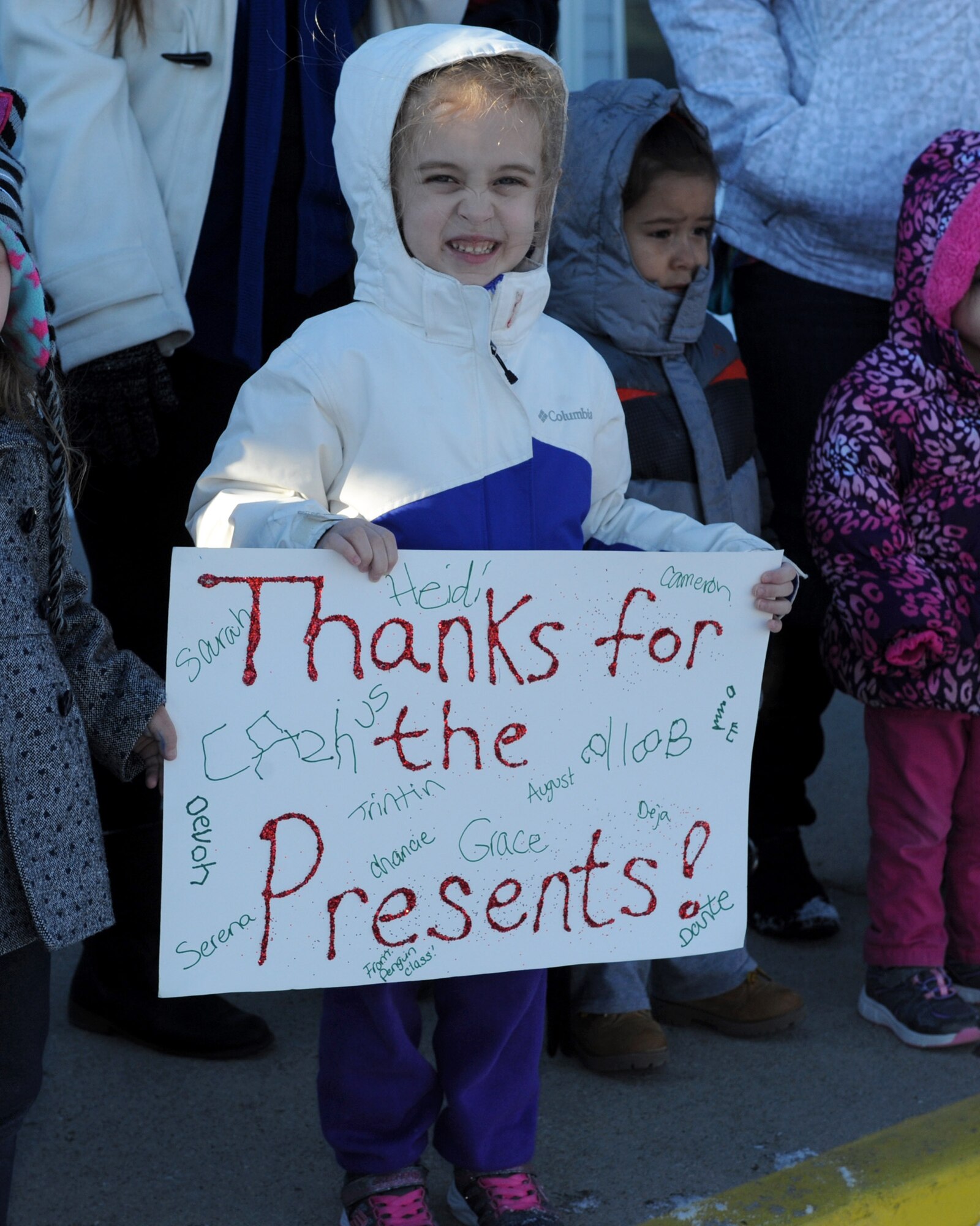 A child holds up a sign for Santa during the annual Angel Tree program at the Youth and Family Services Center in Rapid City, S.D., Dec. 17, 2015. The Angel Tree program is put on annually by the 28th Operations Group from Ellsworth Air Force Base. (U.S. Air Force photo by Airman 1st Class Denise M. Nevins/Released)