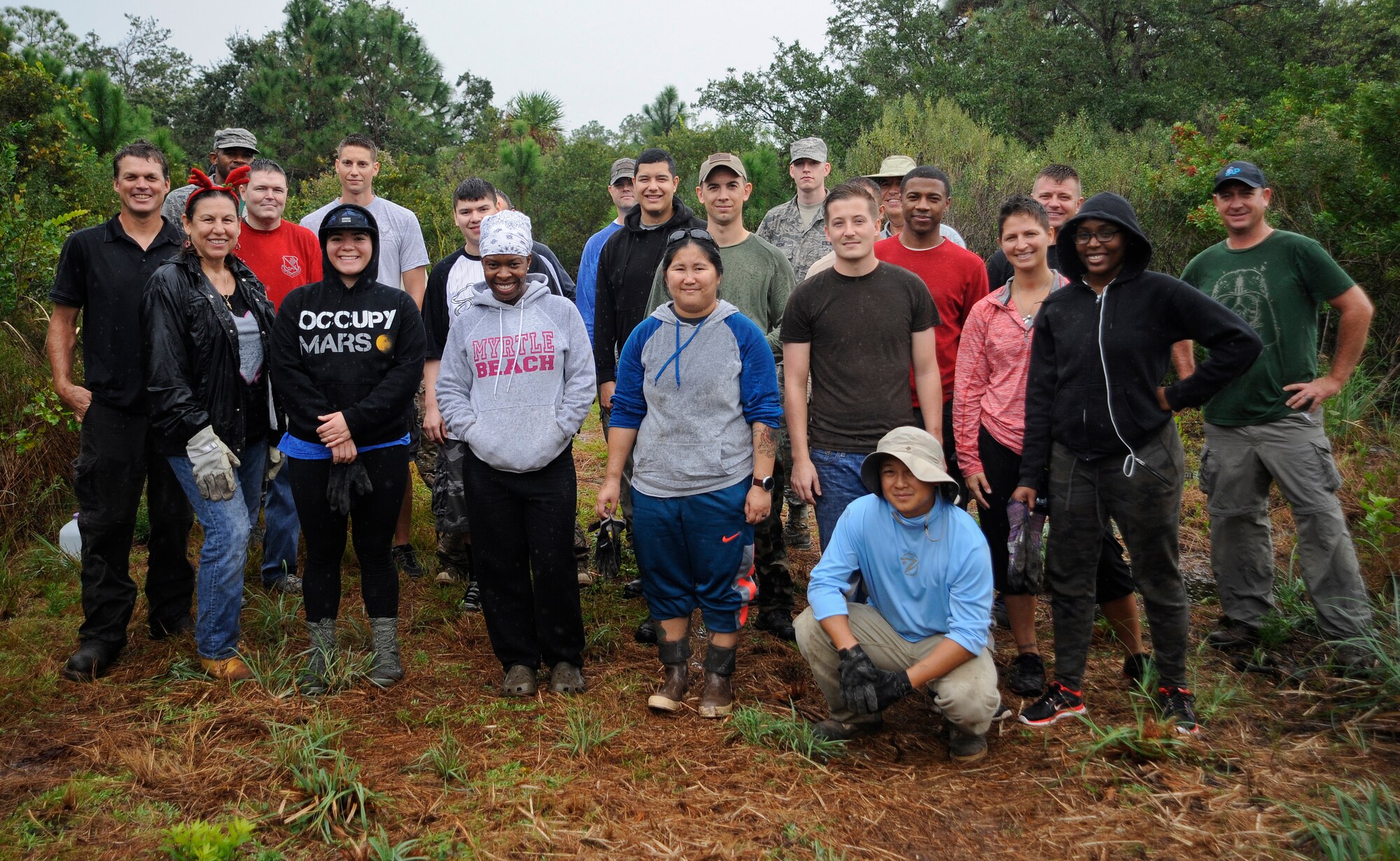 Volunteers pose for a photo after planting trees and plugs during the Wing’s Arbor Day event Dec. 18, 2015, at MacDill Air Force Base, Fla. During the event, volunteers planted 60 Buttonwood trees, 15 Longleaf pine trees, and over 800 plugs of native grasses. (U.S. Air Force photo by Airman 1st Class Mariette M. Adams)