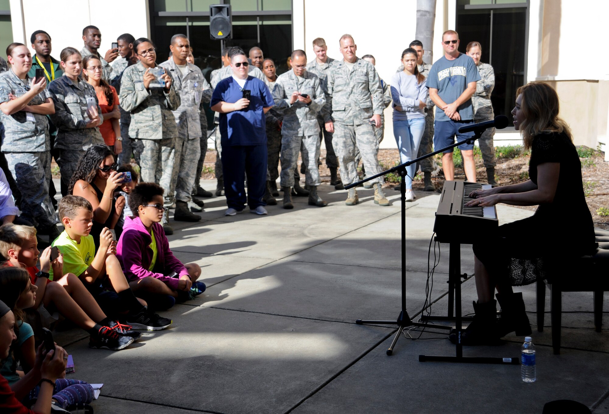 Singer Rachel Platten sings for members of Team MacDill in the 6th Medical Group clinic courtyard at MacDill Air Force Base, Fla., Dec. 14, 2015. Platten chose to perform at the 6th MDG clinic because she sang at patients’ bedsides in hospitals earlier in her career. (U.S. Air Force photo by Airman 1st Class Mariette M. Adams)
