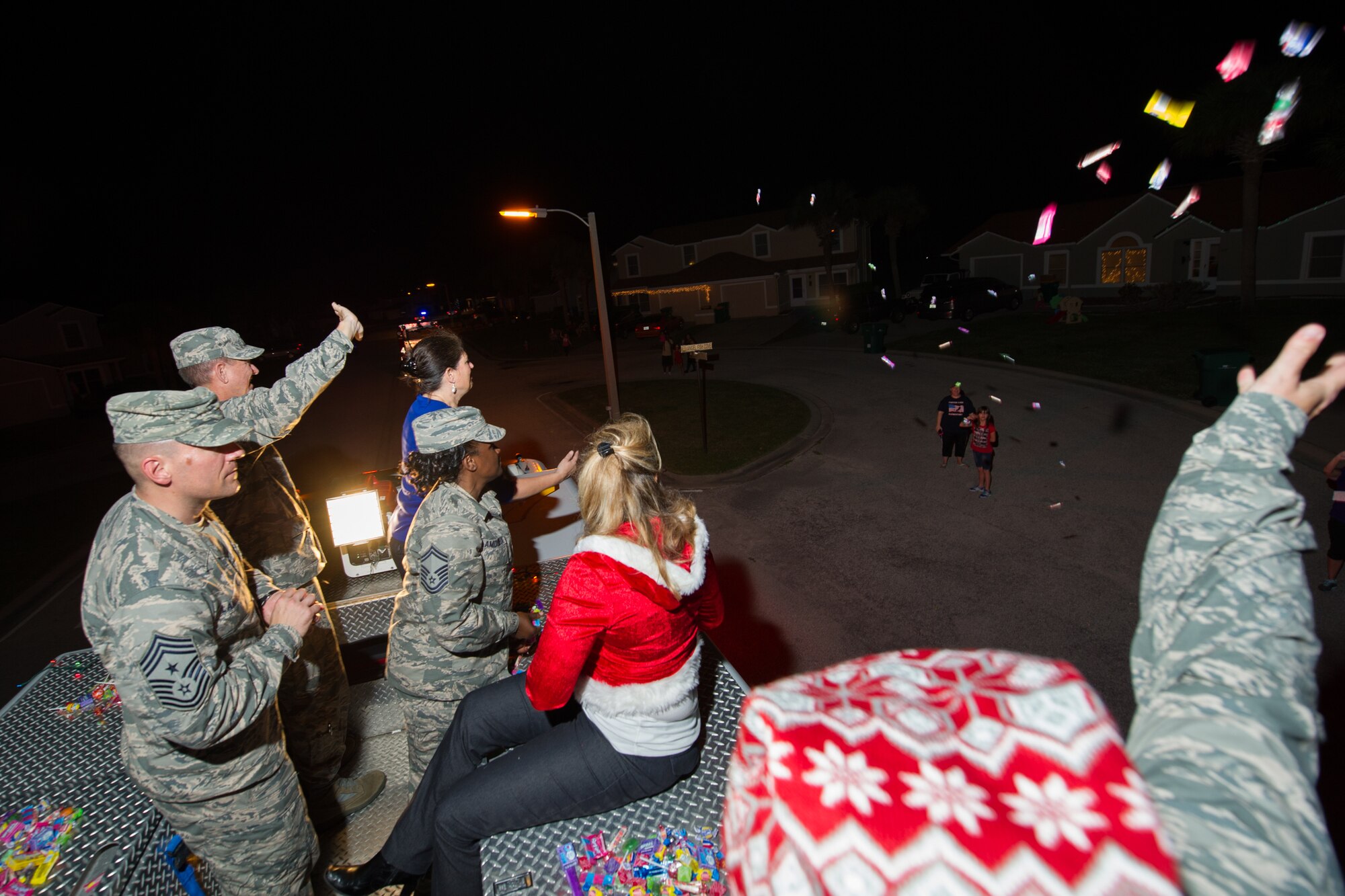 Members of the 45th Space Wing and its mission partners participate in the Holiday Parade, as residents line the sidewalks to witness the event, Dec. 17, 2015, at Patrick Air Force Base, Fla. Fire trucks from Patrick AFB drove around base with Santa, Mrs. Claus, and Sparky the Dog, and greeted residents with handfuls of candy and holiday cheer. (U.S. Air Force photo by Benjamin Thacker) (Released) 