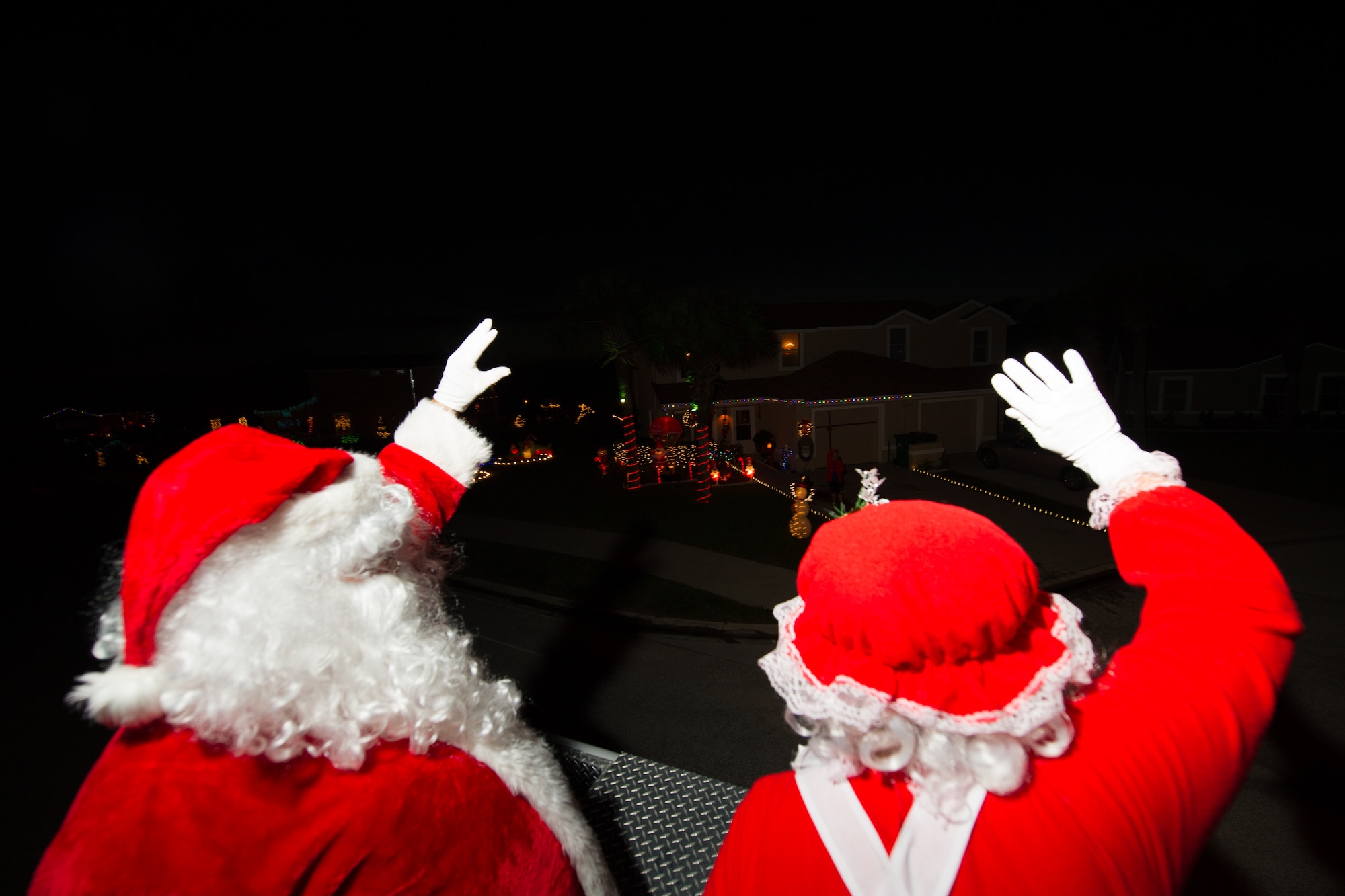 Members of the 45th Space Wing and its mission partners participate in the Holiday Parade, as residents line the sidewalks to witness the event, Dec. 17, 2015, at Patrick Air Force Base, Fla. Fire trucks from Patrick AFB drove around base with Santa, Mrs. Claus, and Sparky the Dog, and greeted residents with handfuls of candy and holiday cheer. (U.S. Air Force photo by Benjamin Thacker) (Released) 