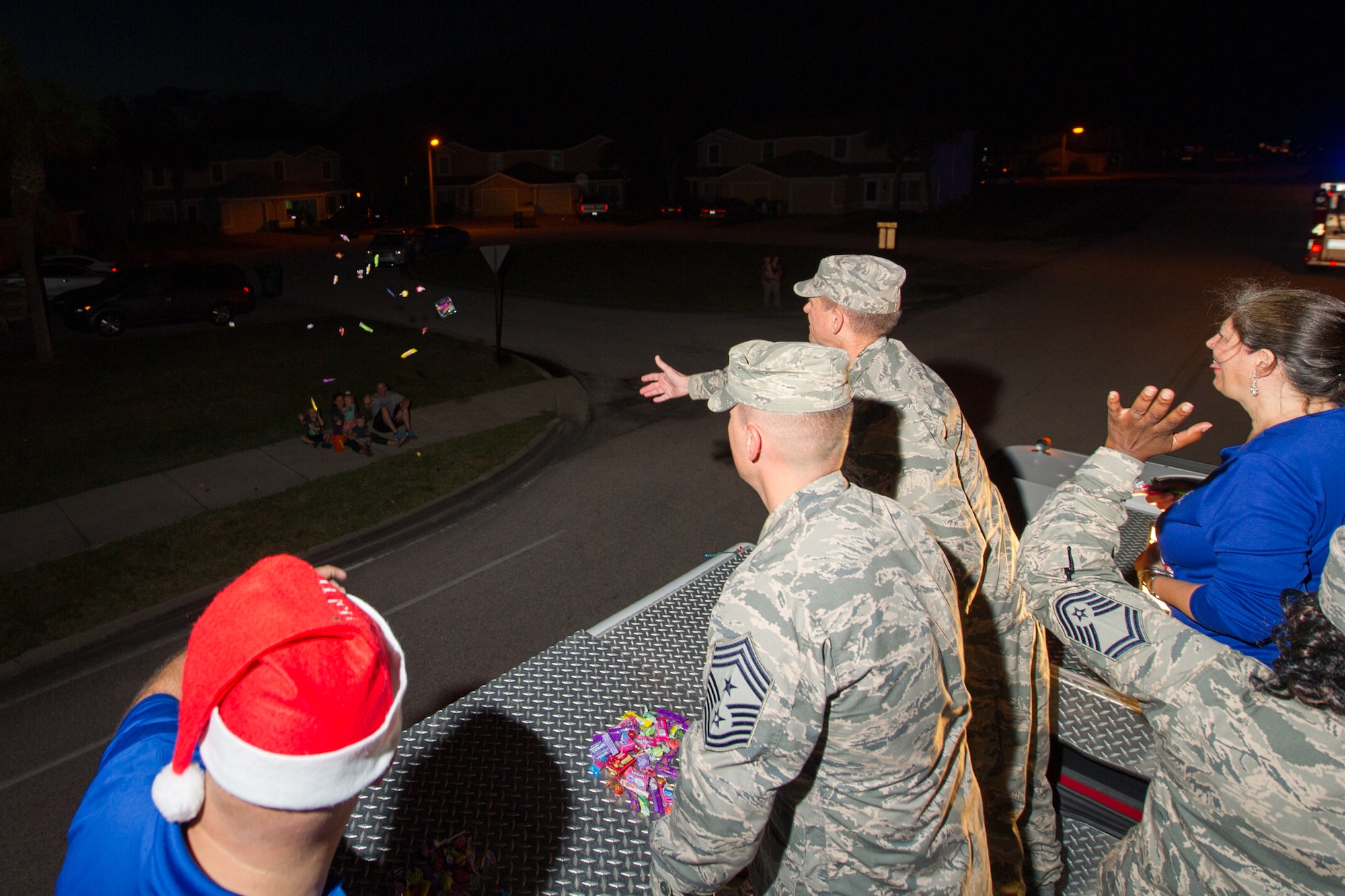 Members of the 45th Space Wing and its mission partners participate in the Holiday Parade, as residents line the sidewalks to witness the event, Dec. 17, 2015, at Patrick Air Force Base, Fla. Fire trucks from Patrick AFB drove around base with Santa, Mrs. Claus, and Sparky the Dog, and greeted residents with handfuls of candy and holiday cheer. (U.S. Air Force photo by Benjamin Thacker) (Released) 