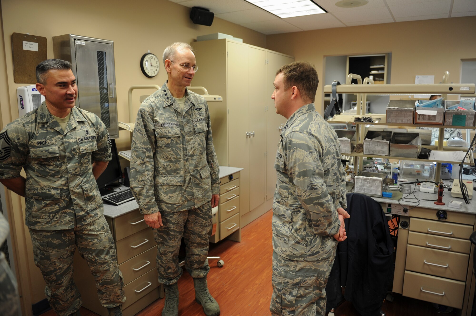 Capt. Chris Girouard, a 19th Aerospace Medicine Squadron dentist, displays the capabilities of the 19th AMDS dental laboratory to U.S. Air Force Surgeon General Lt. Gen. Mark Ediger, center, and Chief Master Sgt. Jason Pace, Medical Enlisted Force chief Dec. 16, 2015, at Little Rock Air Force Base, Ark. The squadron’s dental laboratory Airmen use the latest tools and techniques to craft everything from dentures to crowns and work with dental materials such as acrylic, gypsum and gold. (U.S. Air Force photo/Senior Airman Harry Brexel)