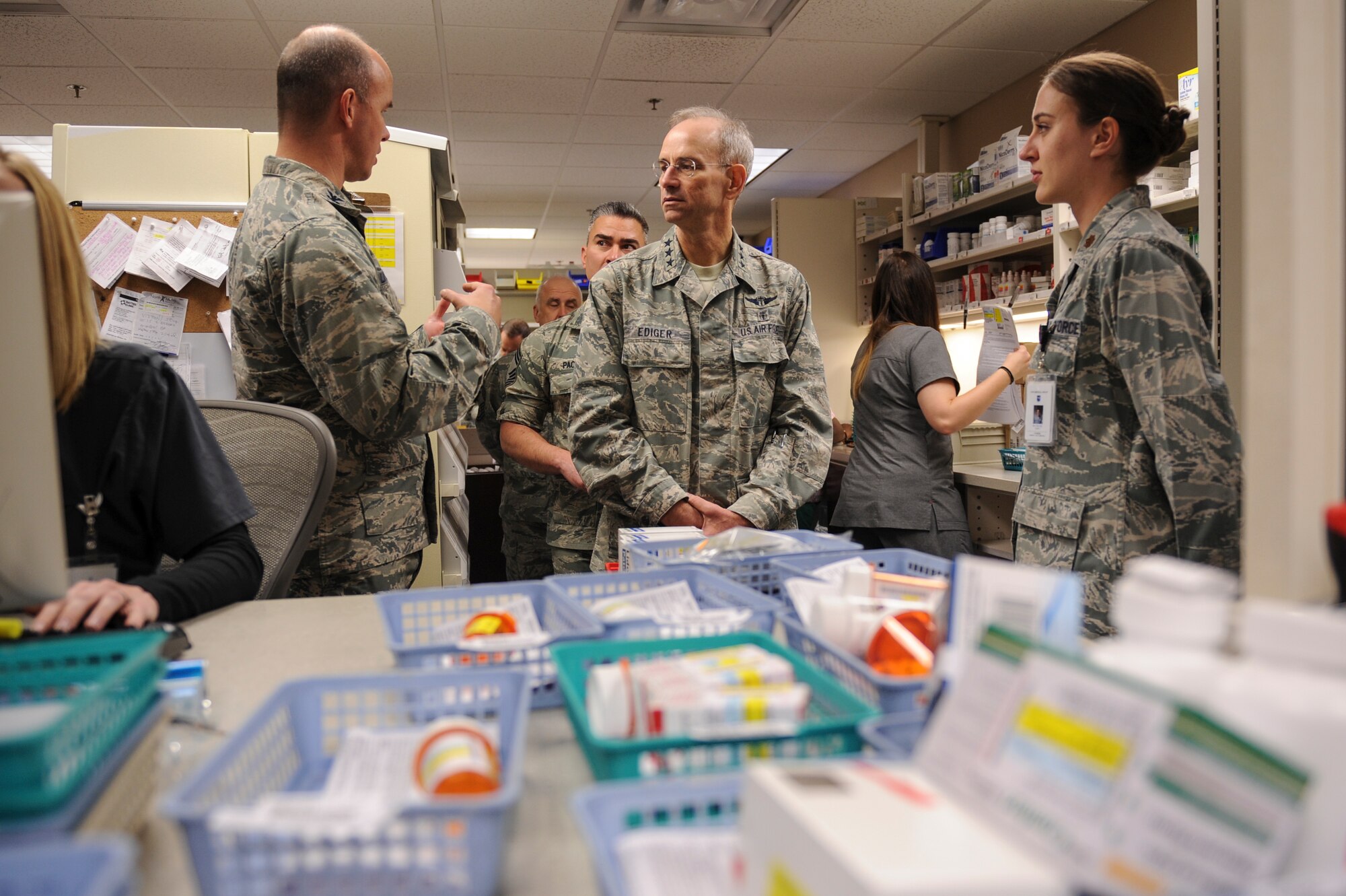 U.S. Air Force Col. Douglas Littlefield, 19th Medical Group commander, left, and Maj. Rachel Casey, 19th Medical Support Squadron pharmacy superintendent, brief U.S Air Force Surgeon General Lt. Gen. Mark Ediger on Dec. 16, 2015, at Little Rock Air Force Base, Ark. During his visit, he received a first-hand look at the role the 19th Medical Group plays in executing Little Rock AFB’s mission and spoke with Airmen. (U.S. Air Force photo/Senior Airman Harry Brexel)