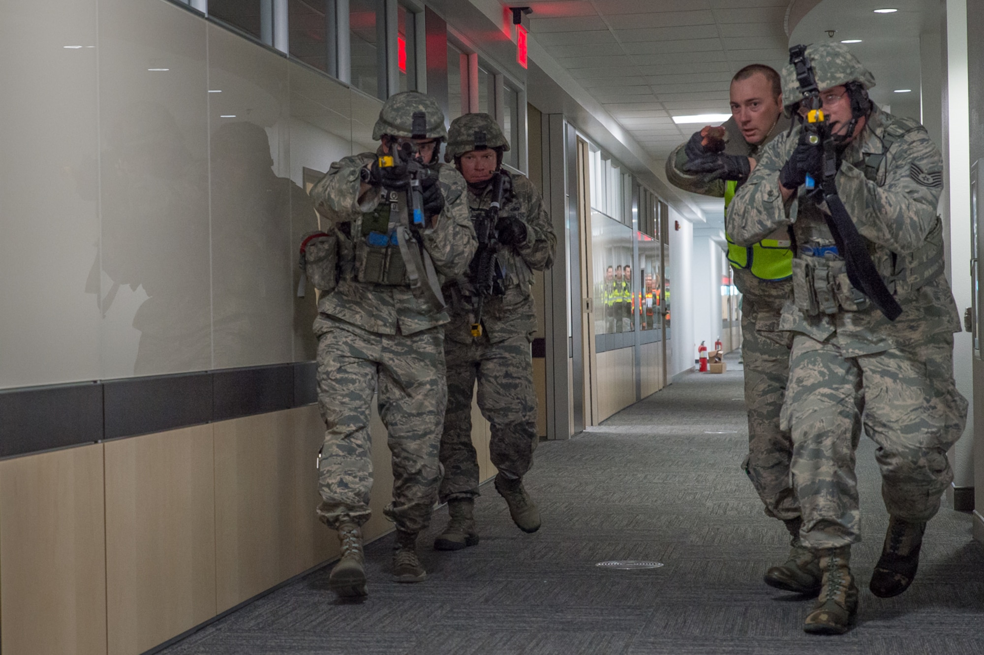 U.S. Air Force Airmen assigned to the 153rd Security Forces Squadron clear a room in the headquarters building Dec. 18, 2015 at Cheyenne Air National Guard base in Cheyenne, Wyoming. The Airmen sweep the building looking for additional gunmen as part of an active shooter exercise. The scenario was in support of memorandum sent by Secretary of the Air Force Deborah James to test lockdown and active shooter procedures in response to shootings in Chattanooga, Tenn. (U.S. Air National Guard photo by Master Sgt. Charles Delano)