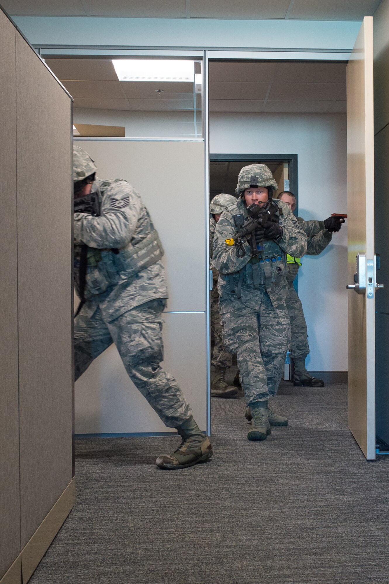 U.S. Air Force Tech. Sgt. Kenneth Paul clears a room in the 153rd Airlift Wing headquarters building Dec. 18, 2015 at Cheyenne Air National Guard base in Cheyenne, Wyoming. Paul and other security forces Airmen look for additional gunmen during an active shooter exercise. The scenario was in support of memorandum sent by Secretary of the Air Force Deborah James to test lockdown and active shooter procedures in response to shootings in Chattanooga, Tenn. (U.S. Air National Guard photo by Master Sgt. Charles Delano)