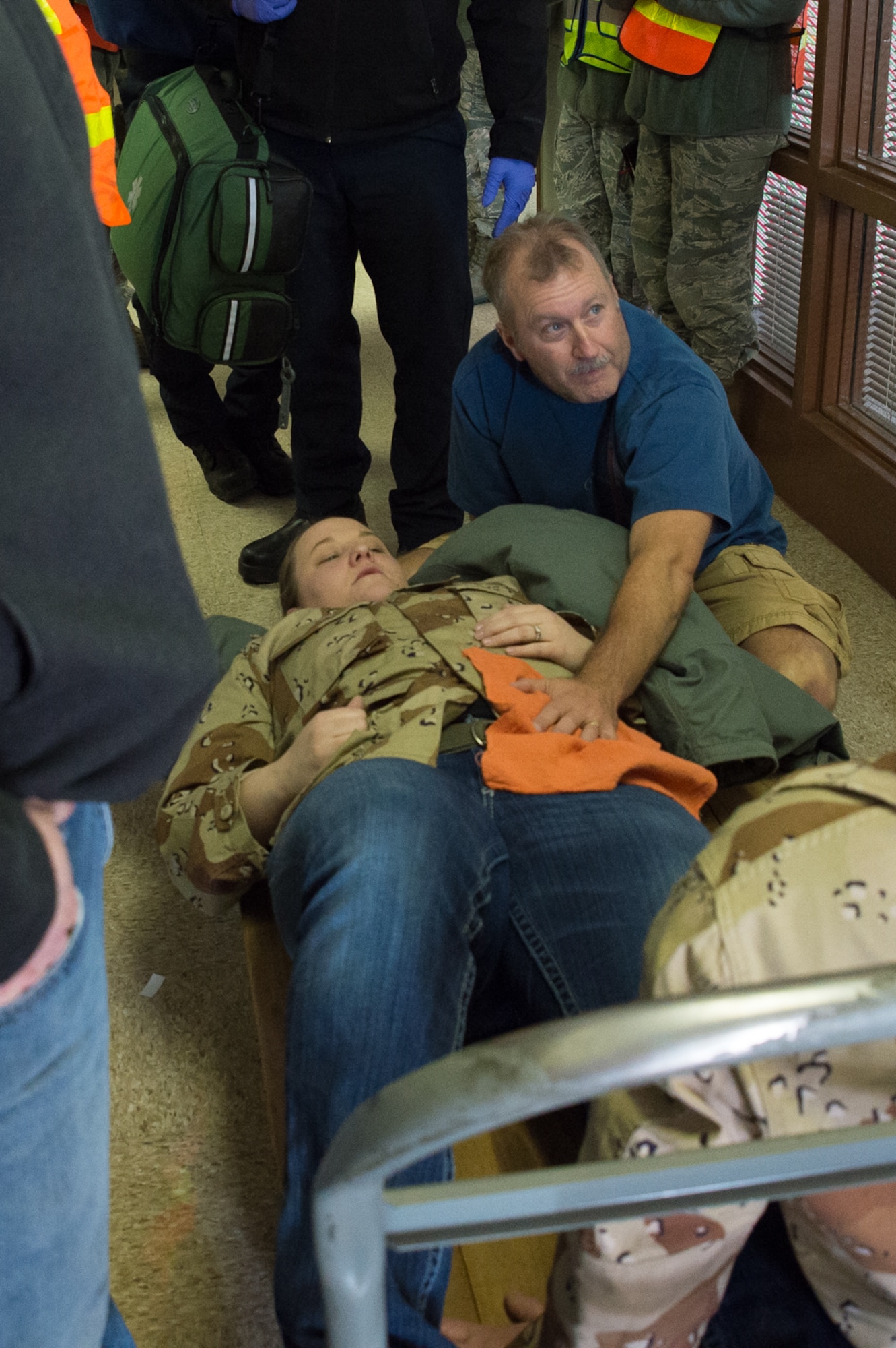 U.S. Air Force Master Sgt. Tim Merritt, 153rd Logistics Readiness Squadron tends to Senior Airman Karen Klein’s simulated wounds, Dec. 18, 2015 at Cheyenne Air National Guard base in Cheyenne, Wyoming. Merritt performed self-aid and buddy care on Klein and other simulated victims during an active shooter exercise. The scenario was in support of memorandum sent by Secretary of the Air Force Deborah James to test lockdown and active shooter procedures in response to shootings in Chattanooga, Tenn. (U.S. Air National Guard photo by Master Sgt. Charles Delano)