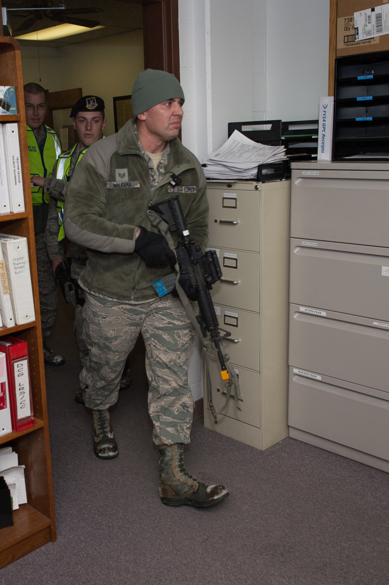 U.S. Air Force Staff Sgt. Chance Walkama, 153rd Security Forces Squadron, walks through a doorway, Dec. 18, 2015 at Cheyenne Air National Guard base in Cheyenne, Wyoming. Walkama portrayed a lone gunman during an active shooter exercise attempting to fatally wound as many people as possible before being captured or killed. The scenario was in support of memorandum sent by Secretary of the Air Force Deborah James to test lockdown and active shooter procedures in response to shootings in Chattanooga, Tenn. (U.S. Air National Guard photo by Master Sgt. Charles Delano)