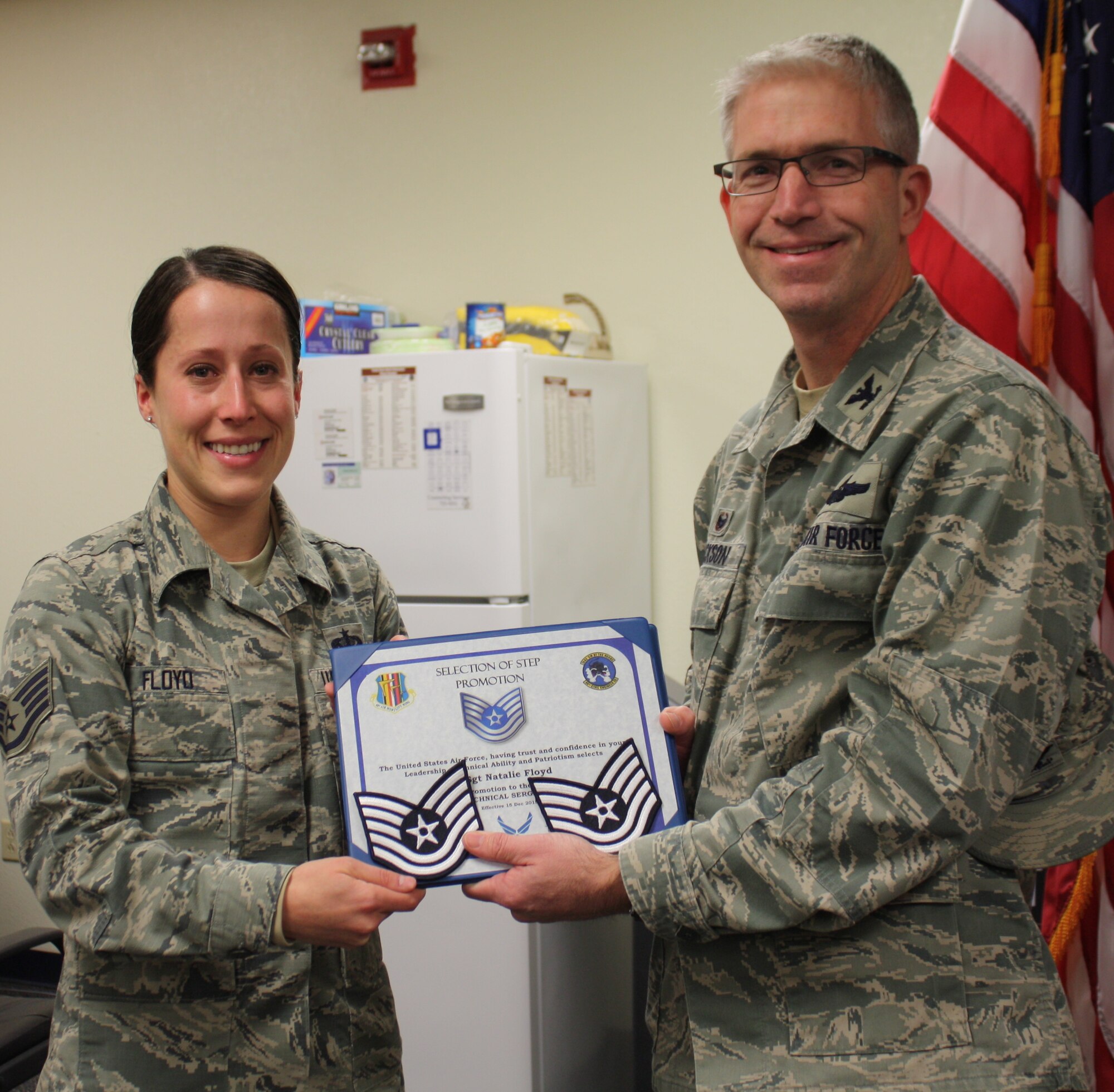 Staff Sgt. Natalie Floyd, 60th Air Mobility Wing dorm manager, was caught totally by surprise when 60th Air Mobility Wing Commander, Col. Joel Jackson, walked in on her staff meeting. It has come to my attention someone here is out of uniform, he said. A stunned and emotional Floyd was promoted to technical sergeant immediately, under the Stripes for Exceptional Performers program. Christmas came a little early for you this year, congratulations, Jackson said. Floyd is assigned to the 60th Civil Engineer
Squadron. The dorm manager is a special duty assignment, in which she has far exceeded all expectations, according to Jackson. (U.S. Air Force photo/Ellen Hatfield)

