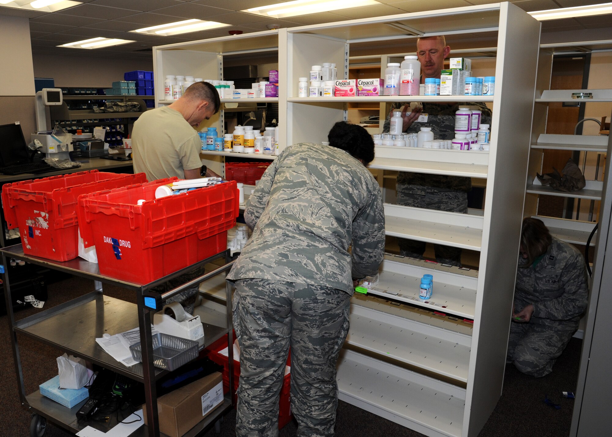 Airmen with the 319th Medical Group put the finishing touches on the new pharmacy location Dec. 18, 2015, on Grand Forks Air Force Base, North Dakota. After more than eight months, the $9.2 million renovation to the Medical Treatment Facility was finished. (U.S. Air Force photo by Airman 1st Class Ryan Sparks/Released)