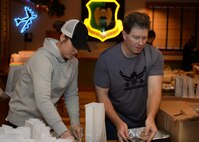 Julie McGinnis, Officers’ Spouses’ Club member and Gene Brandt, husband of Maj. Olga Brandt,5th Contracting Squadron commander, bag cookies during the 2015 Airmen Cookie Drive at Minot Air Force Base, N.D., Dec. 11, 2015. This is McGinnis’ second year volunteering at the cookie drive which provides cookies to Airmen living in the dorms and for those working during the holidays. (U.S. Air Force photo/Airman 1st Class Matt Rauschnot)