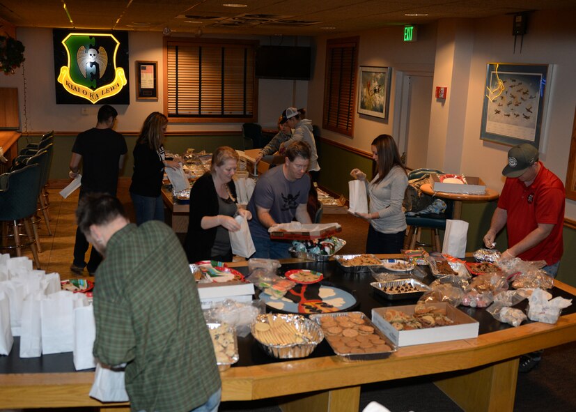 Volunteers help bag cookies during the 2015 Airmen Cookie Drive at Minot Air Force Base, N.D., Dec. 11, 2015. More than 15,000 cookies were donated to give to single Airmen living in the dorms and for Airmen working during the holidays. (U.S. Air Force photo/Airman 1st Class Matt Rauschnot)