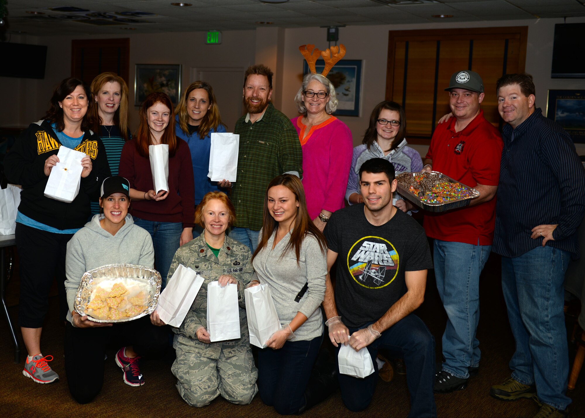 Volunteers of the 2015 Airmen Cookie Drive pose for a group photo at Minot Air Force Base, N.D., Dec. 11, 2015. Volunteers prepared bags of cookies donated by base personnel as well as companies and families of the local area as a way to spread holiday cheer. (U.S. Air Force photo/Airman 1st Class Matt Rauschnot)
