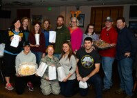 Volunteers of the 2015 Airmen Cookie Drive pose for a group photo at Minot Air Force Base, N.D., Dec. 11, 2015. Volunteers prepared bags of cookies donated by base personnel as well as companies and families of the local area as a way to spread holiday cheer. (U.S. Air Force photo/Airman 1st Class Matt Rauschnot)