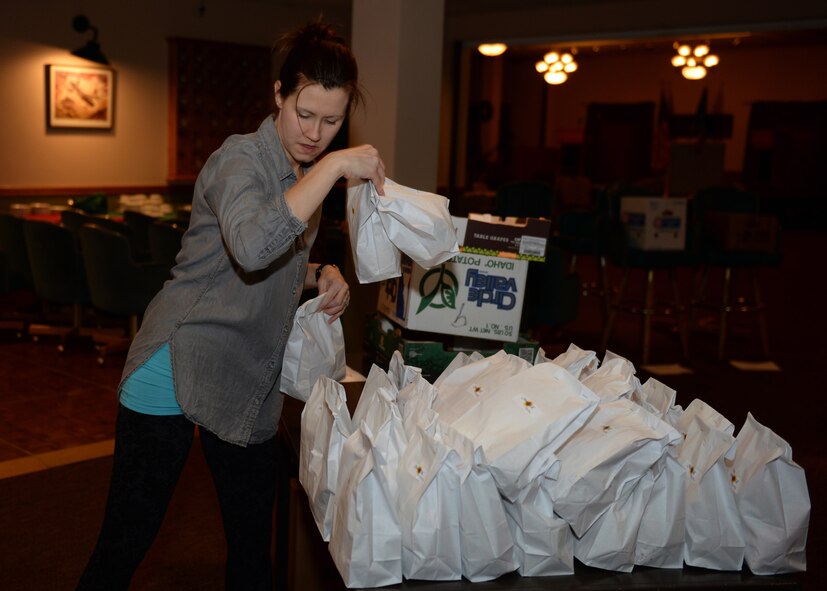 Audra Owens, Officers’ Spouses’ Club member, sorts cookie bags during the 2015 Airmen Cookie Drive at Minot Air Force Base, N.D., Dec. 11, 2015. This is Owens’ third year volunteering at the cookie drive which provides cookies to Airmen living in the dorms and for those working during the holidays. (U.S. Air Force photo/Airman 1st Class Matt Rauschnot)