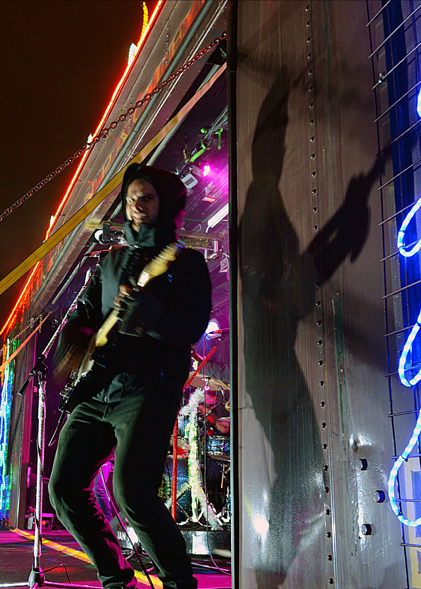 A guitarist for the Holiday Train Band performs on the Canadian Pacific Holiday Train at the Old Soo Depot Transportation Museum in Minot, N.D., Dec. 15, 2015. The train visits communities in Quebec, New York and southern Ontario before traveling across states in the northeast and Midwest, before returning to Canada for its final stops in Saskatchewan and Alberta. The Holiday Train travels through dozens of communities, raising food and cash donations for North American food banks. (U.S. Air Force photo/Airman 1st Class Matt Rauschnot)