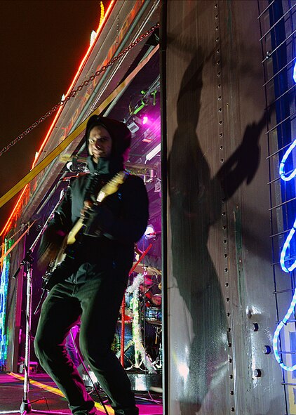 A guitarist for the Holiday Train Band performs on the Canadian Pacific Holiday Train at the Old Soo Depot Transportation Museum in Minot, N.D., Dec. 15, 2015. The train visits communities in Quebec, New York and southern Ontario before traveling across states in the northeast and Midwest, before returning to Canada for its final stops in Saskatchewan and Alberta. The Holiday Train travels through dozens of communities, raising food and cash donations for North American food banks. (U.S. Air Force photo/Airman 1st Class Matt Rauschnot)