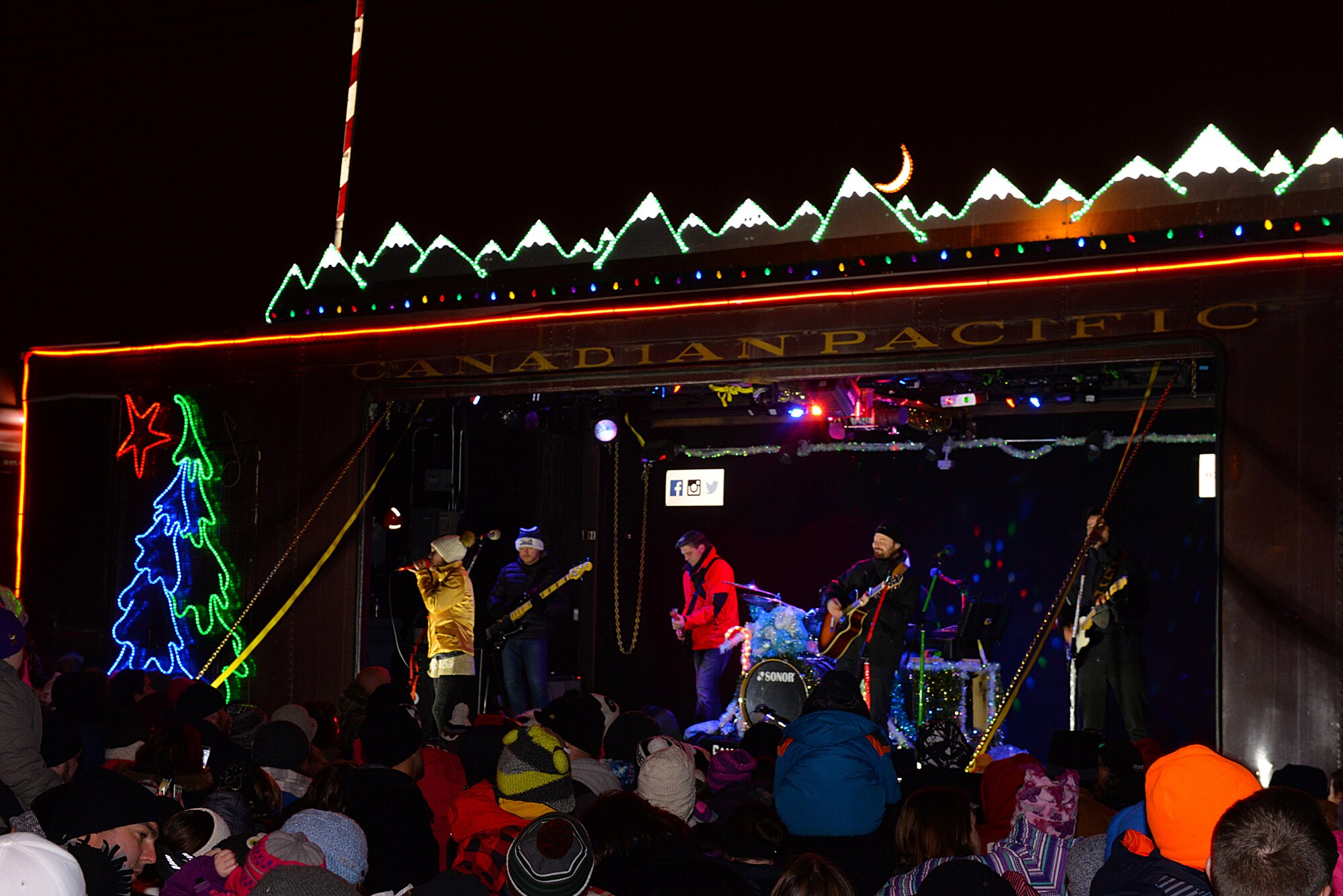 Kira Isabella, a Canadian country singer, and the Holiday Train Band performs on the Canadian Pacific Holiday Train at the Old Soo Depot Transportation Museum in Minot, N.D., Dec. 15, 2015. The Holiday Train travels through dozens of communities, raising food and cash donations for North American food banks. This year train donated $6,000 to the Minot Area Homeless Coalition. (U.S. Air Force photo/Airman 1st Class Matt Rauschnot)