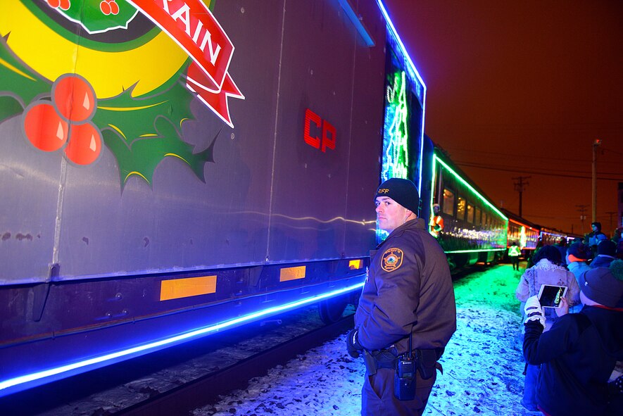 A sheriff deputy of Ward County, N.D., ensured public safety as the Canadian Pacific Holiday Train stops at the Old Soo Depot Transportation Museum in Minot, N.D., Dec. 15, 2015. The train visits communities in Quebec, New York and southern Ontario before traveling across states in the northeast and Midwest, before returning to Canada for its final stops in Saskatchewan and Alberta. The train features 14 railcars decorated with hundreds of thousands of lights and holiday-themed performances by professional musicians. (U.S. Air Force photo/Airman 1st Class Matt Rauschnot)