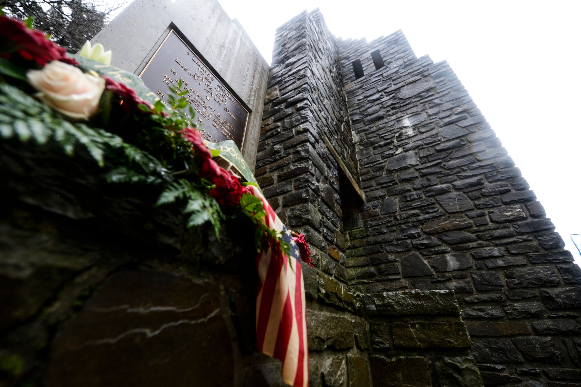 A wreath rests on the National Liberation Memorial at Schumanns Eck, Luxembourg, Dec. 16, 2015.  The plaque on the memorial reads ‘To the honor and in memory of our allied liberators and all those who contributed to restore liberty and justice.’ (U.S. Air Force photo by Staff Sgt. Christopher Ruano/Released)