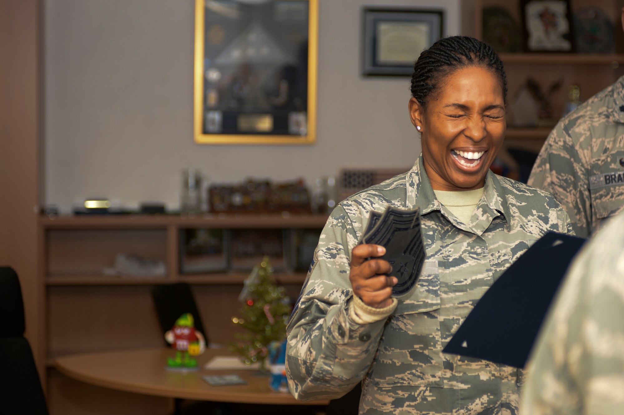U.S. Air Force Senior Master Sgt. Anitra Nesbitt, 52nd Logistics Readiness Squadron, exclaims after being surprised by 52nd Fighter Wing leadership that she earned selection for promotion to chief master sergeant while at her squadron at Spangdahlem Air Base, Germany, Dec. 17, 2015. Nine 52nd FW senior master sergeants earned selection to chief master sergeant. (U.S. Air Force photo by Staff Sgt. Joe W. McFadden/Released)