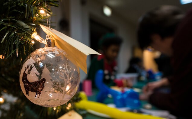 A Christmas ornament hangs from a tree at the Ramstein Community Center’s Elf Boot Camp Dec. 14, 2015, at Ramstein Air Base, Germany. The children at the event participated in multiple activities to see if they had the qualities to be an elf at the North Pole. Activities for Elf Boot Camp included creating an elf identification badge, making elf hats and taste-testing cookies. (U.S. Air Force photo/Airman 1st Class Tryphena Mayhugh)