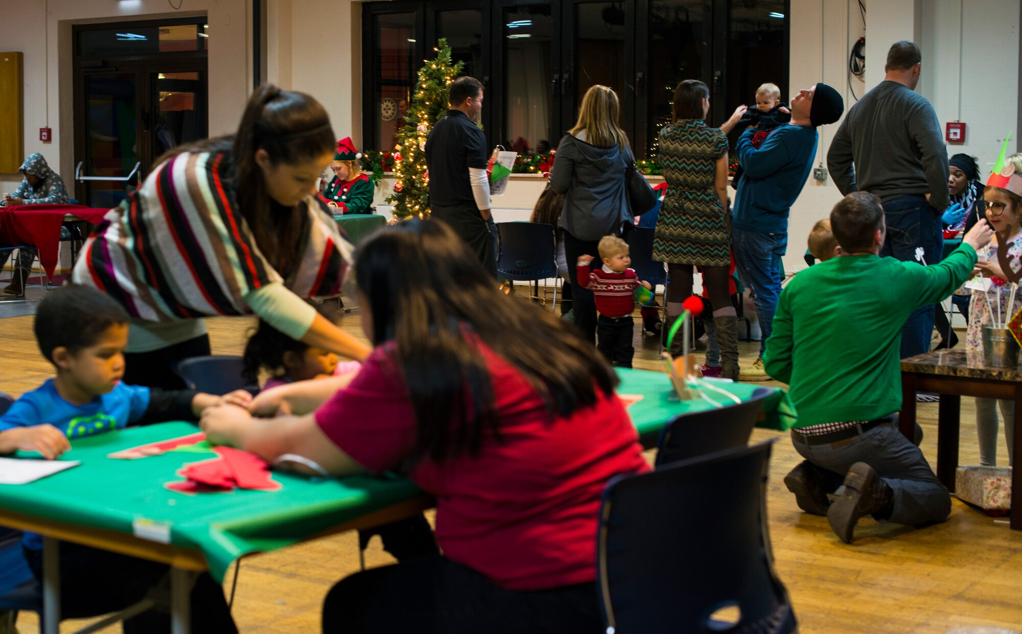 Patrons participate in the Ramstein Community Center’s Elf Boot Camp Dec. 14, 2015, at Ramstein Air Base, Germany. Children were able to make their own elf hats and elf identification badges, taste-tested cookies and practice wrapping gifts. (U.S. Air Force photo/Airman 1st Class Tryphena Mayhugh)