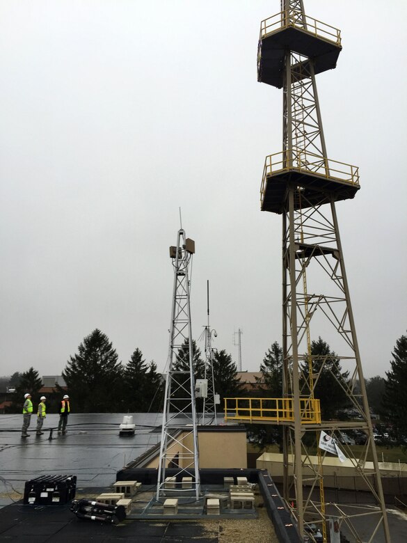 Airmen inspect the new 120-foot radio tower attached to the Hanscom Collaboration and Innovation Center at Hanscom Air Force Base, Mass., Dec. 17, 2015. The $3.1 million project is part of a facility upgrade geared at doubling communication range and fostering new partnerships with federal, state, academic and industry organizations. (U.S. Air Force photo by Justin Oakes)