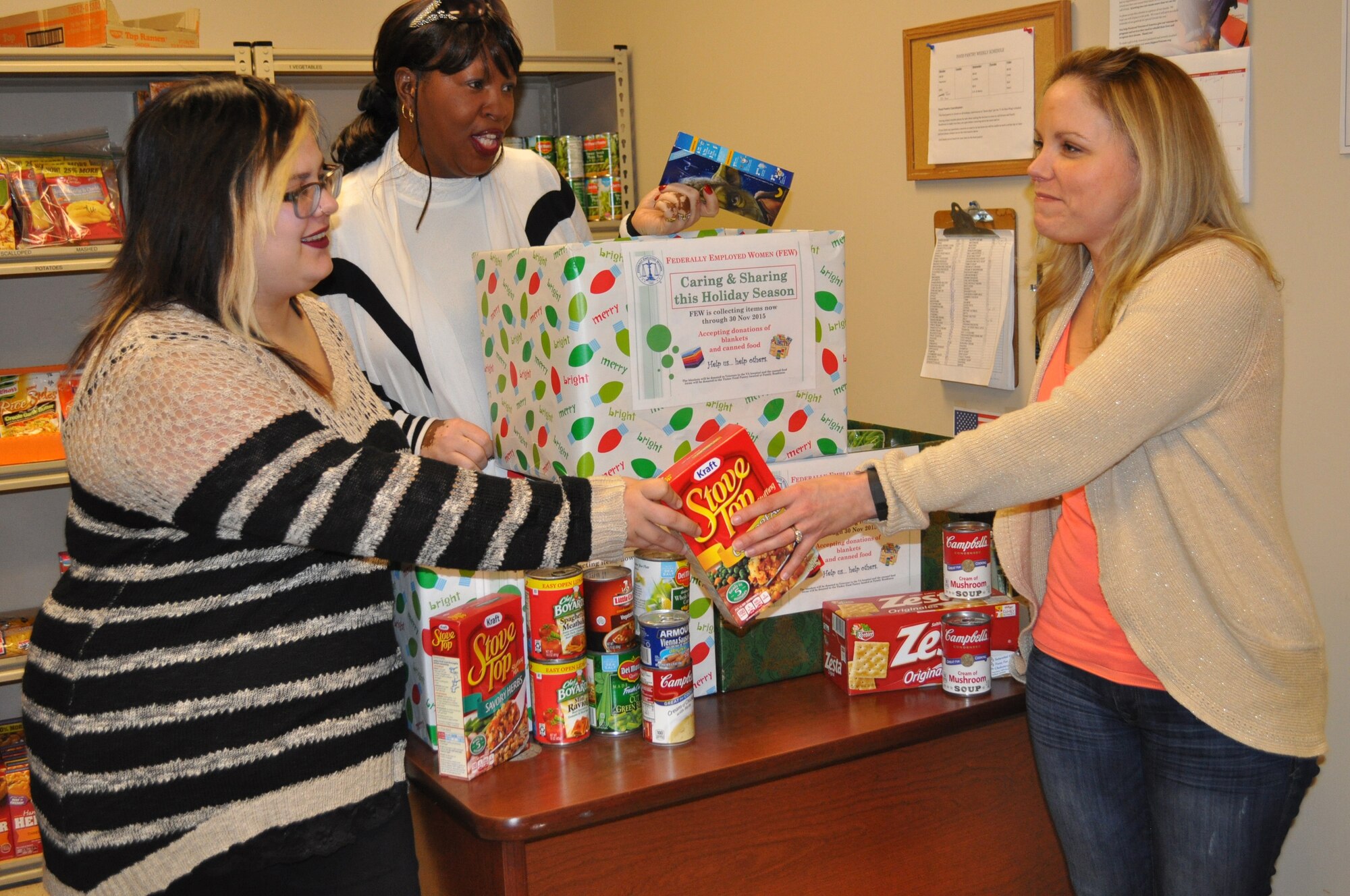 Last week the Tinker chapter of Federally Employed Women made a donation of 103.6 pounds of non-perishable food items to the Tinker Food Pantry. Gia Easley, with the Airman and Family Readiness Center, right, accepted the donation from Beverly Jones, FEW president, center, and Macy Garcia, a University of Central Oklahoma student volunteer. The FEW recently sponsored a “Caring & Sharing for the Holidays” community service project collecting food and blankets. The blankets collected will be donated to veterans at the VA hospital. For more information regarding FEW, contact Ms. Jones at beverly.jones@us.af.mil or visit FEW.org. (Air Force photo by Kelly White/Released)